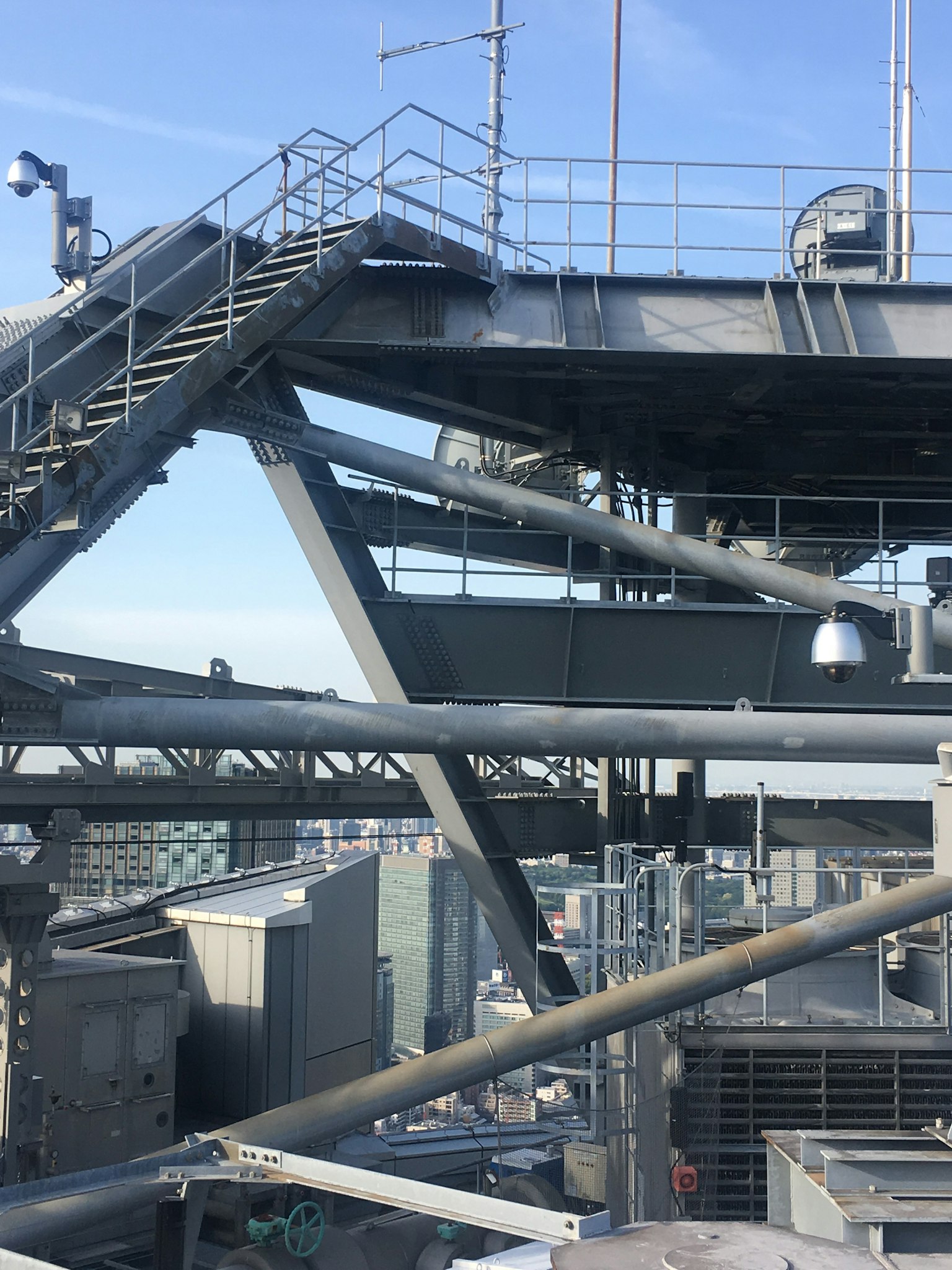 Industrial rooftop view featuring metal stairs and frameworks