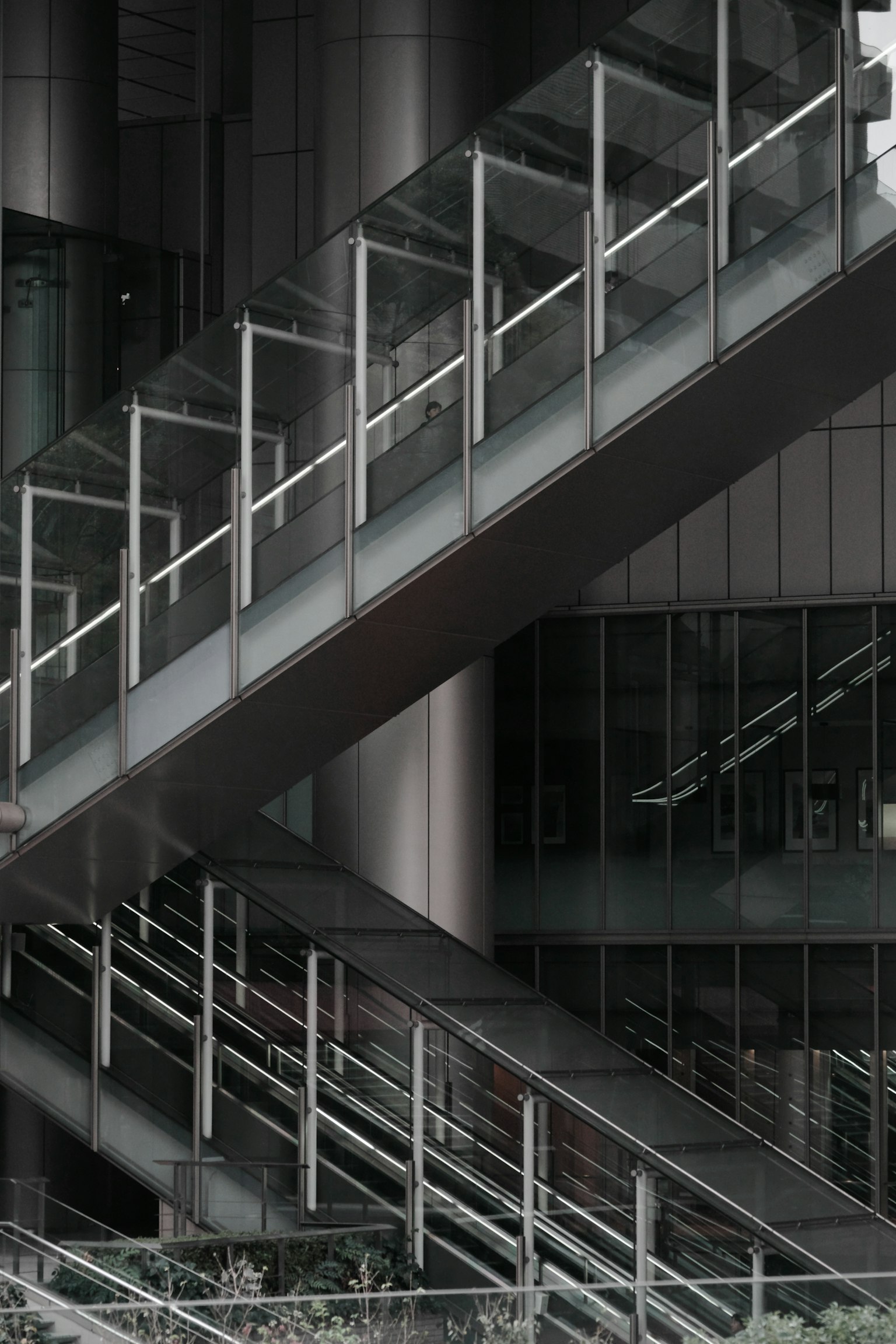 Detailed view of a modern staircase with glass railings in a contemporary building