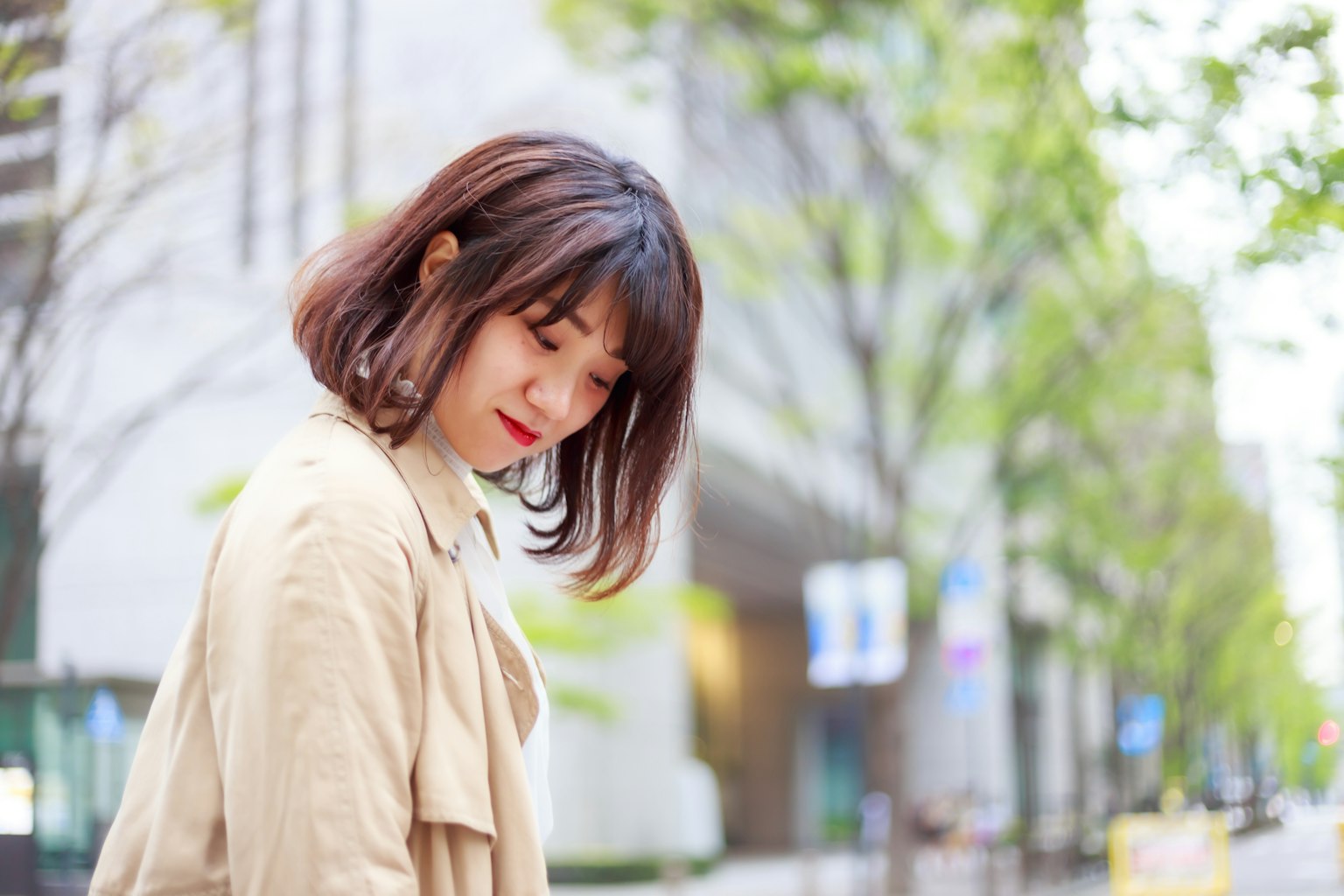 A woman smiling brightly while walking in the city