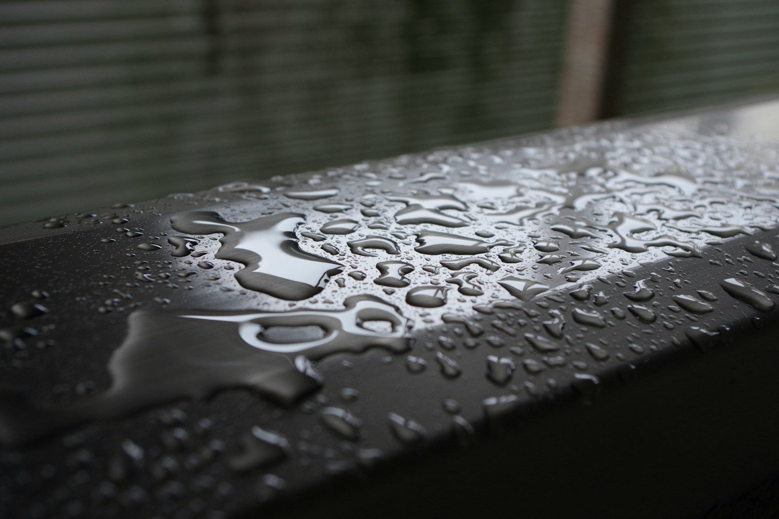 Close-up of water droplets on a dark surface