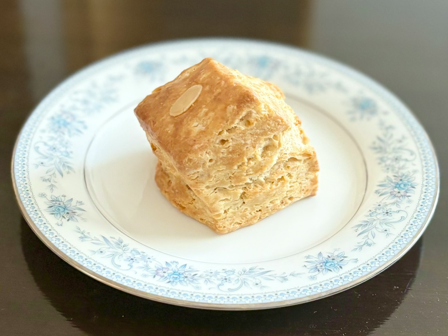 一塊烘焙食品在白色花卉圖案的盤子上