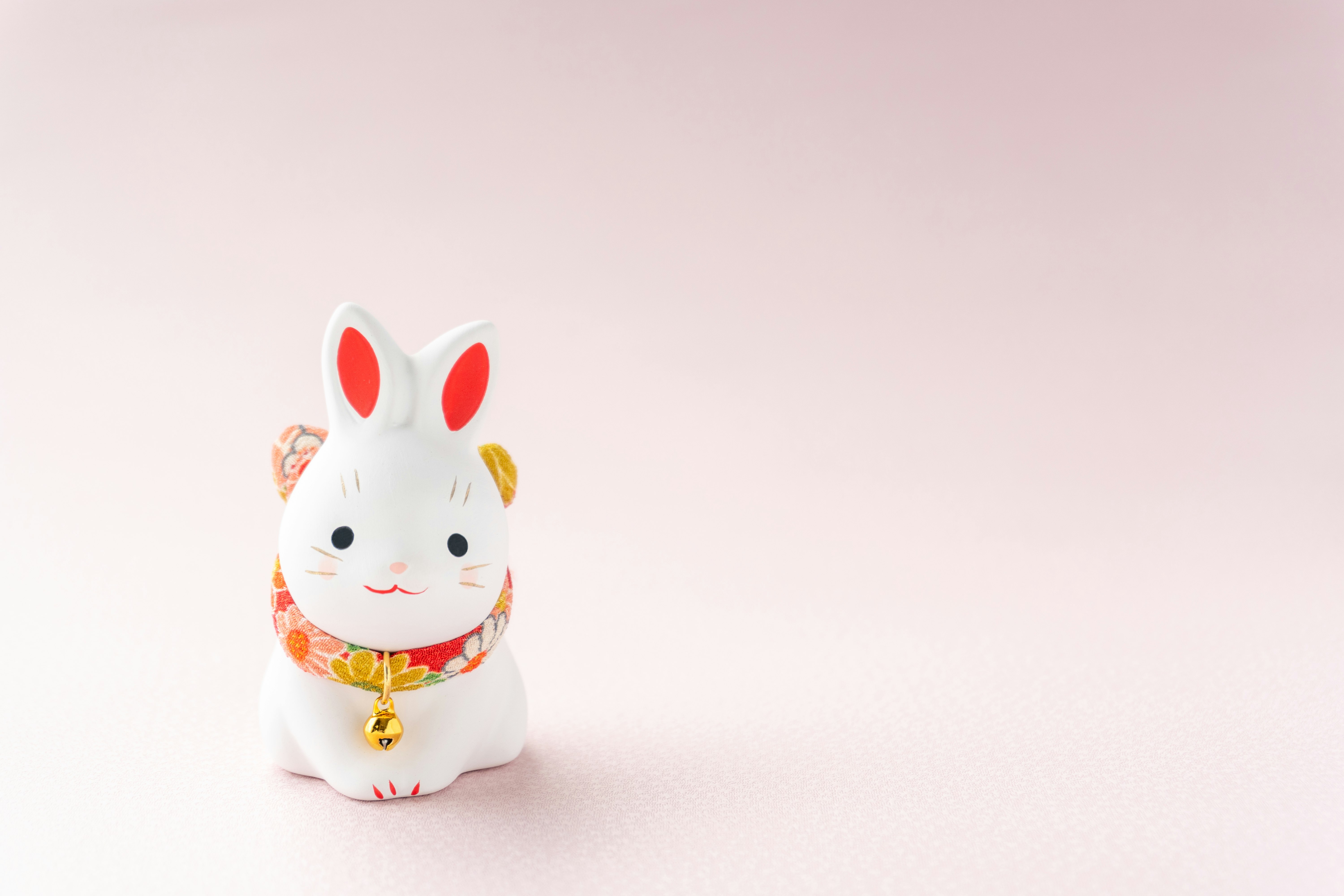 A lucky white rabbit figurine placed on a white background
