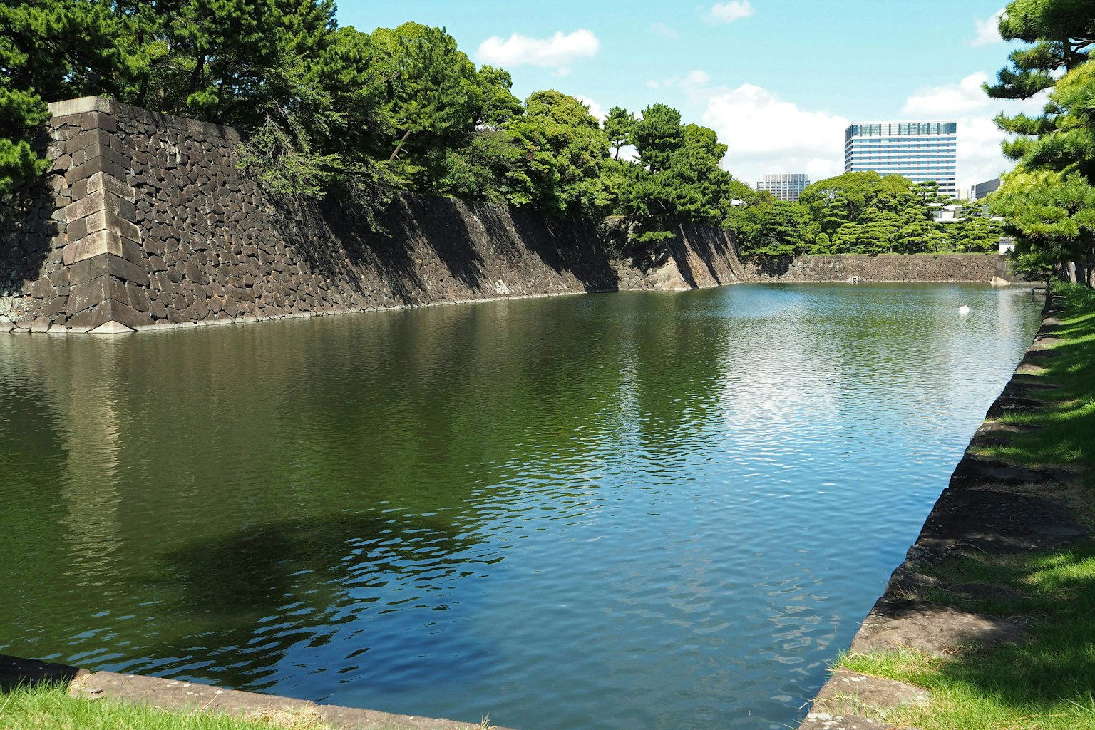 Scenic view of a stone moat surrounded by greenery