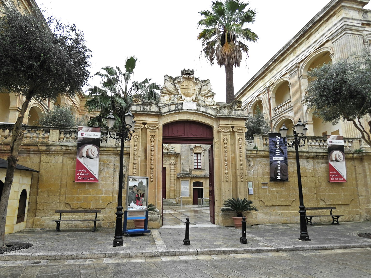 Entrance of a historical building with palm trees