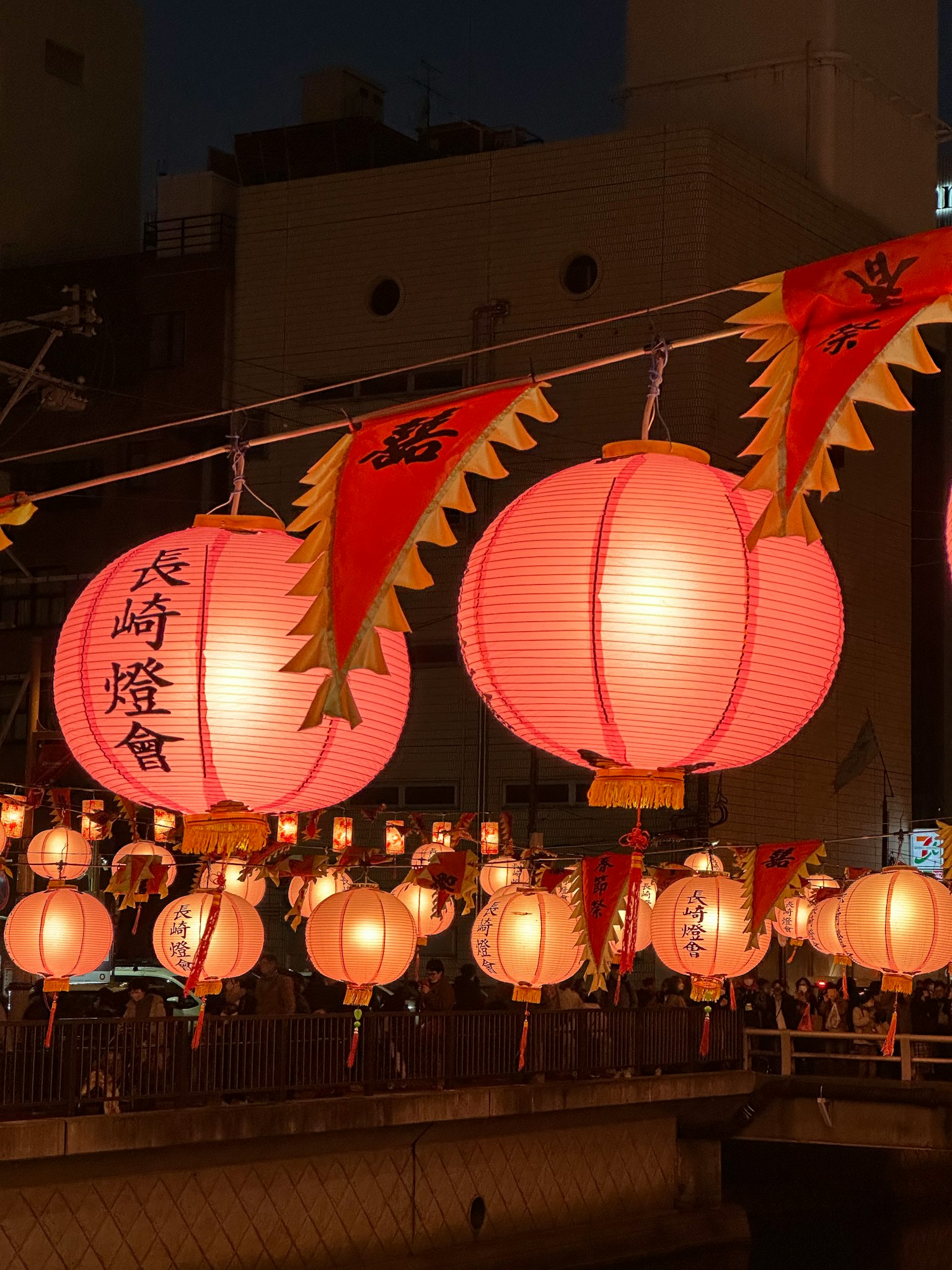 Red lanterns and decorations along a river at night