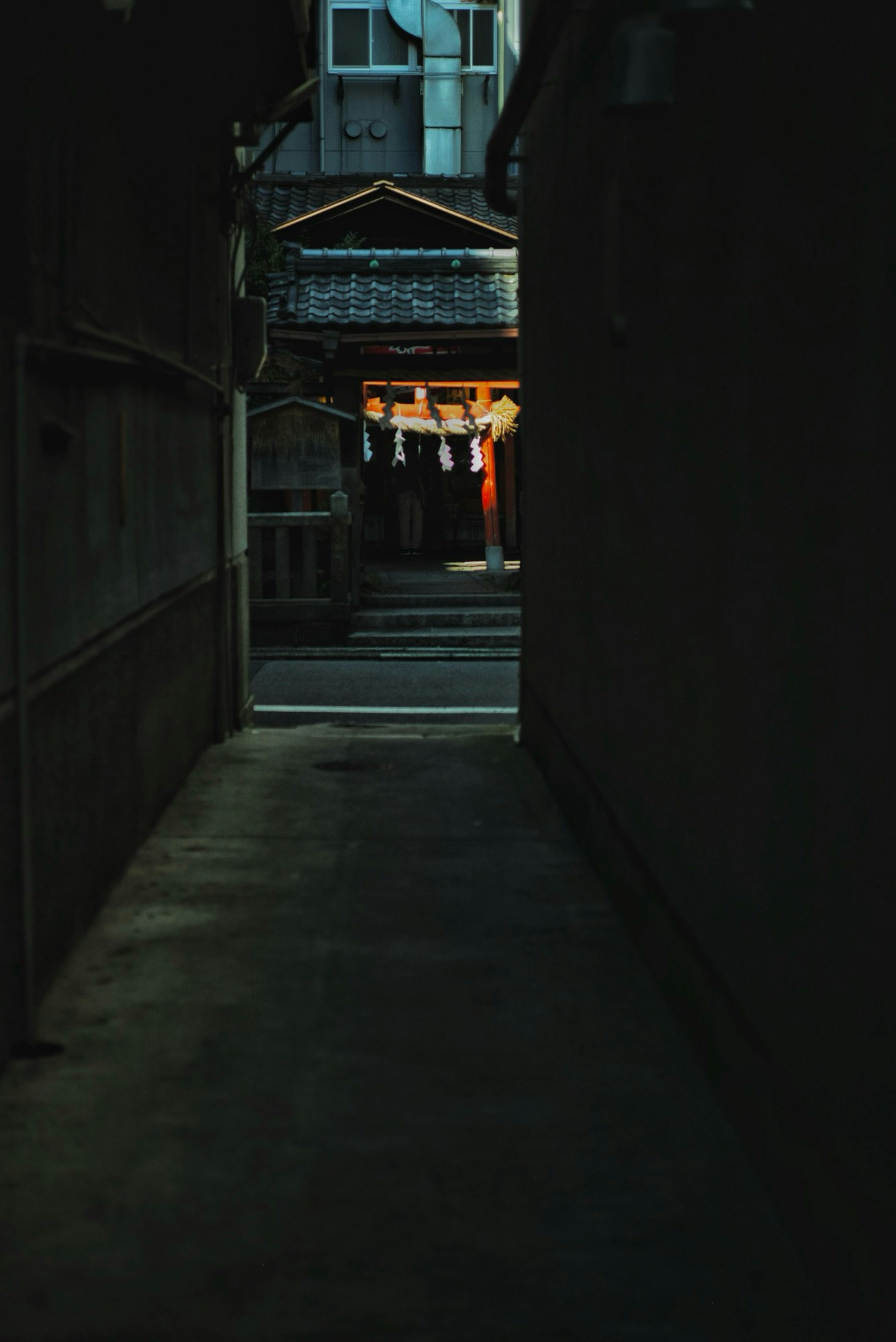 Torii gate at the end of a narrow alley at Misaki Shrine Tosa Inari