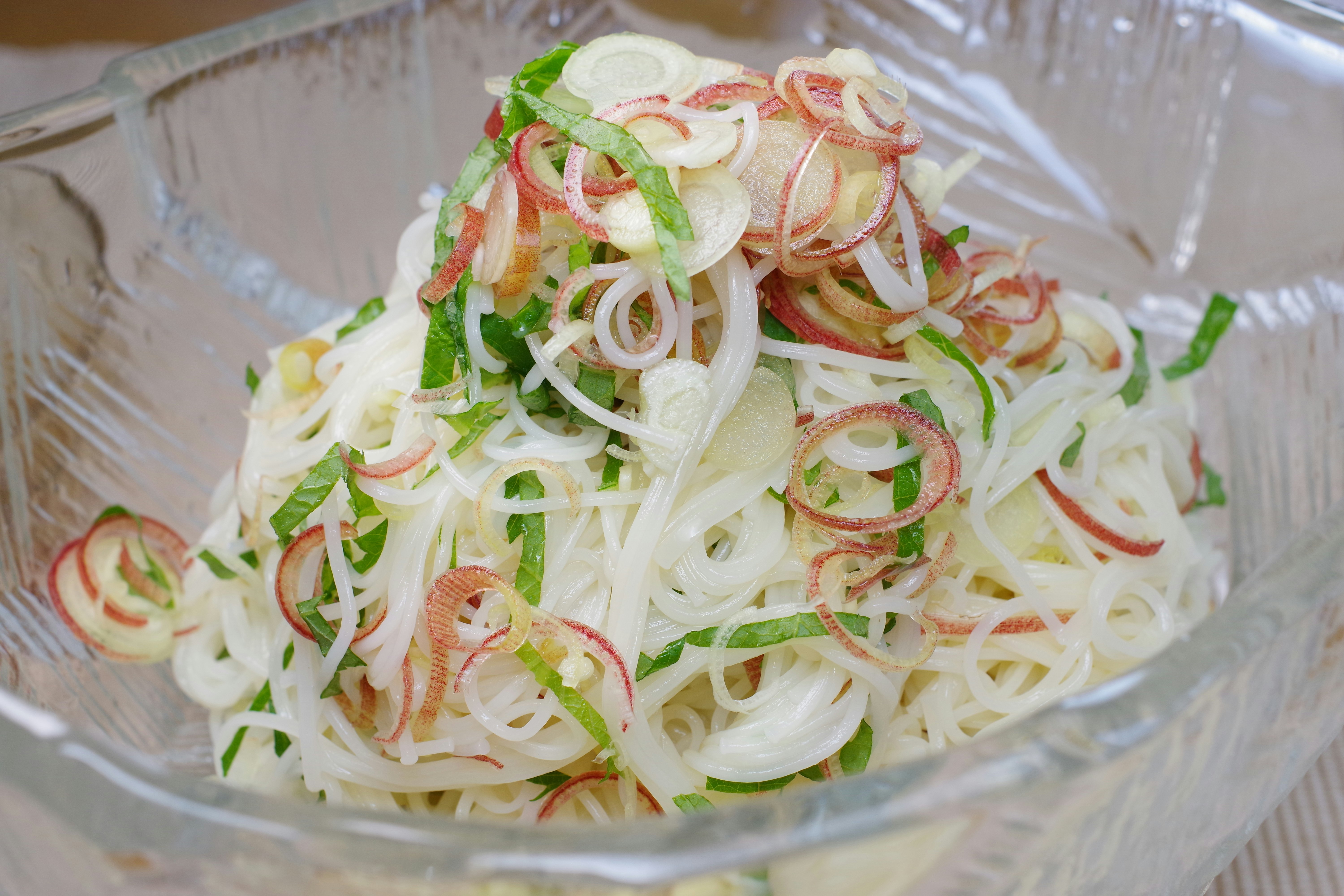 bowl of white noodles with sliced vegetables