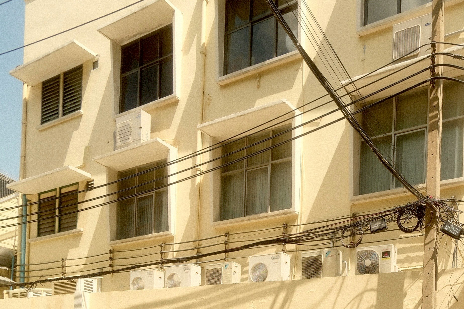 電線が張り巡らされた集合住宅の外観