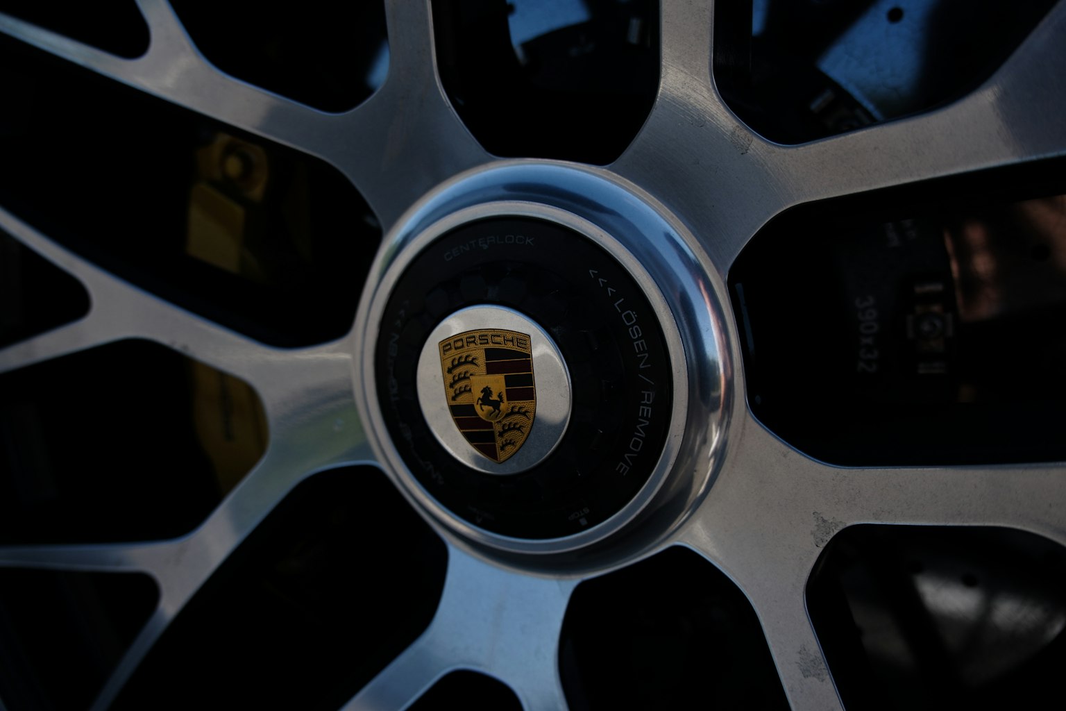 Close-up of a Porsche wheel hub featuring sharp design and glossy finish