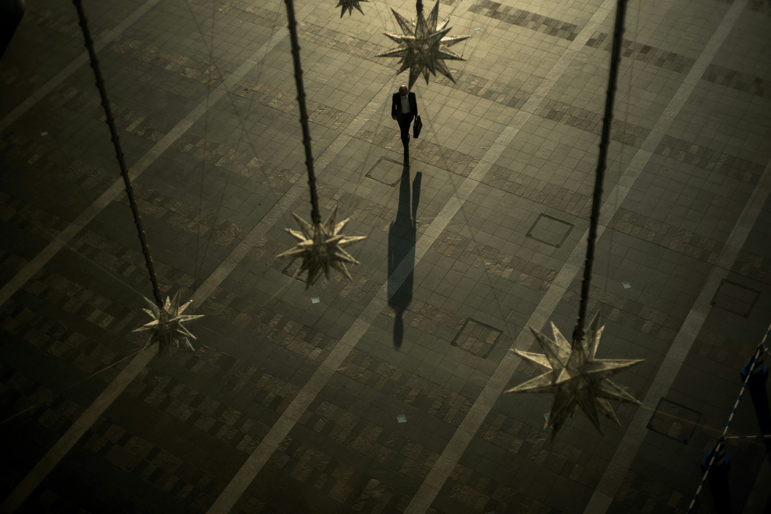 A person standing in a dimly lit space with star-shaped decorations