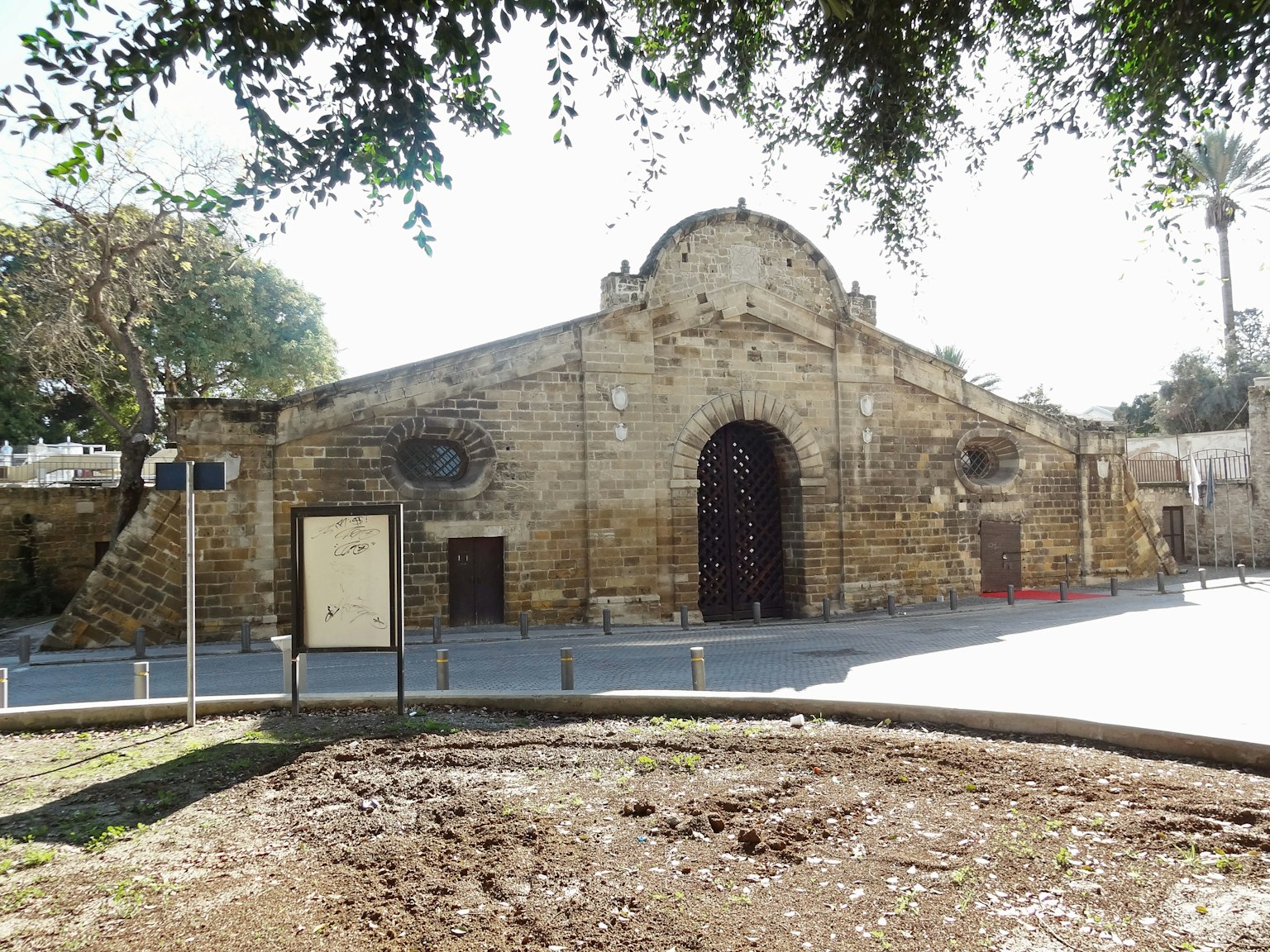Exterior of an ancient stone building featuring a large wooden door