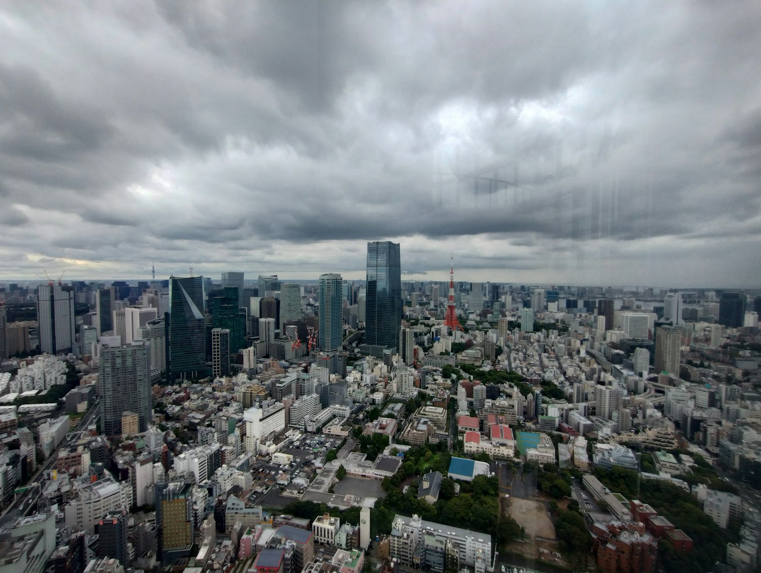 Panoramic view of Tokyo skyscrapers under a cloudy sky