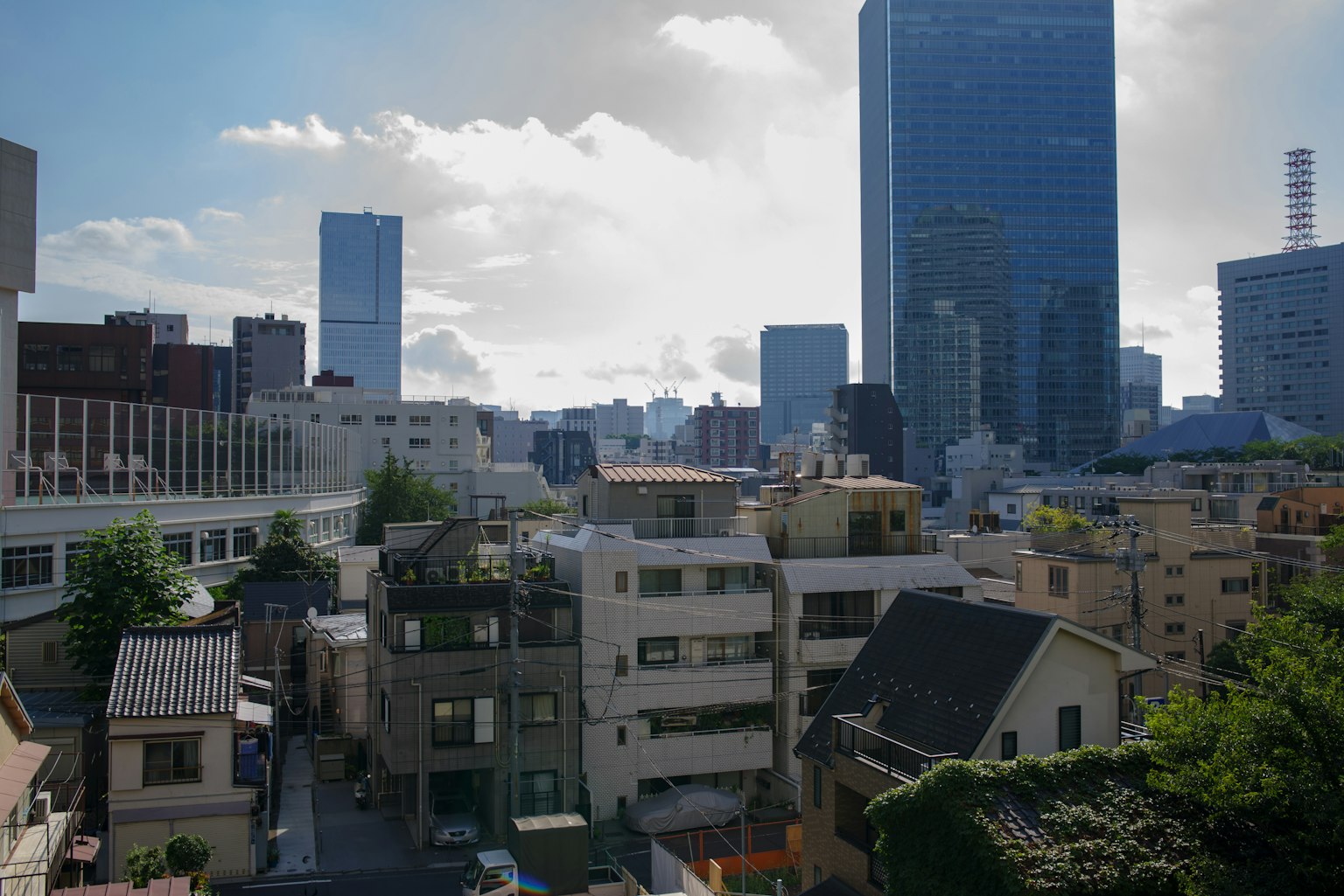 Tokyo cityscape featuring skyscrapers and a cloudy sky