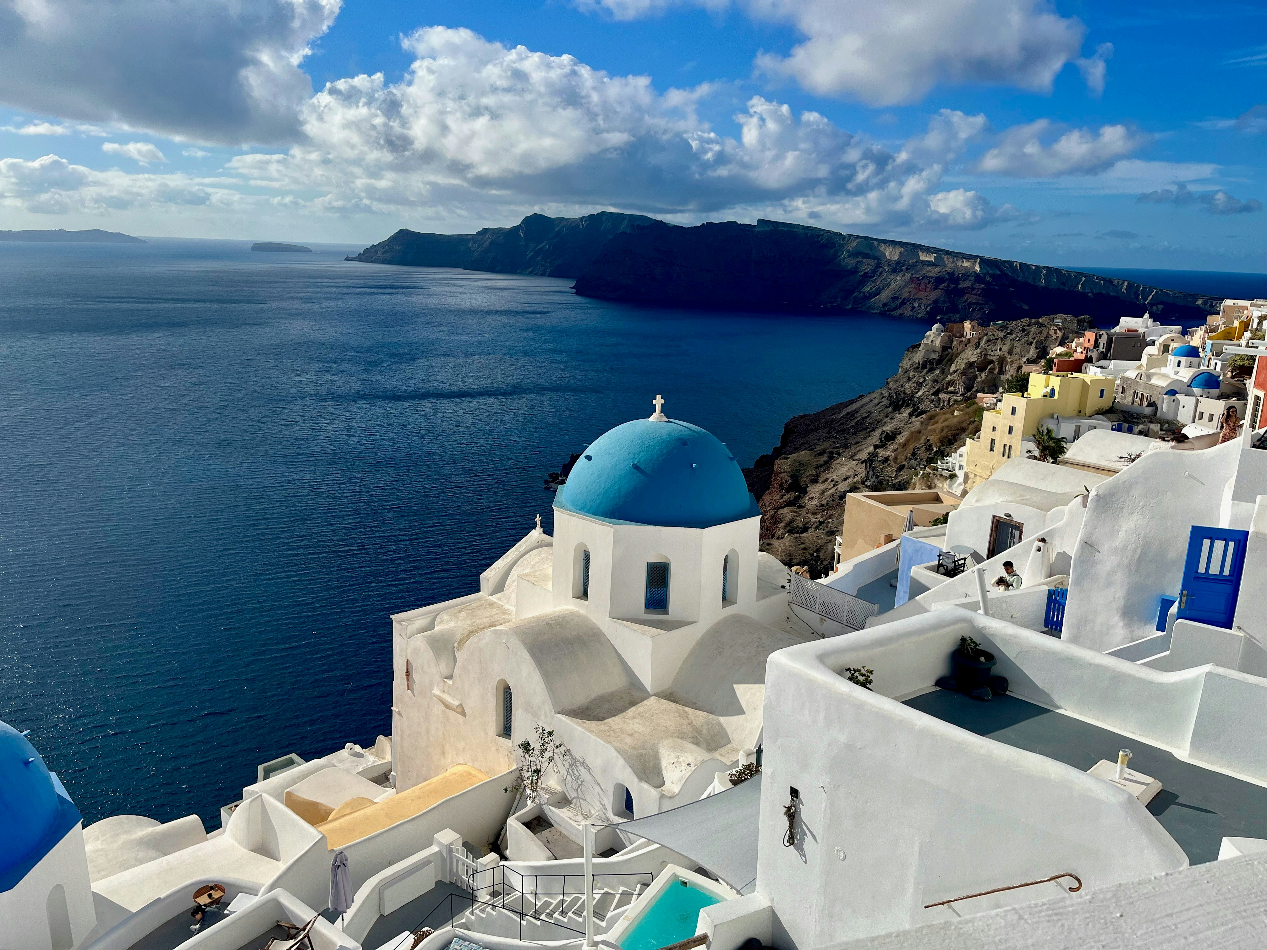 Oia, Santorini blue-domed white townscape by the sea in the morning sun