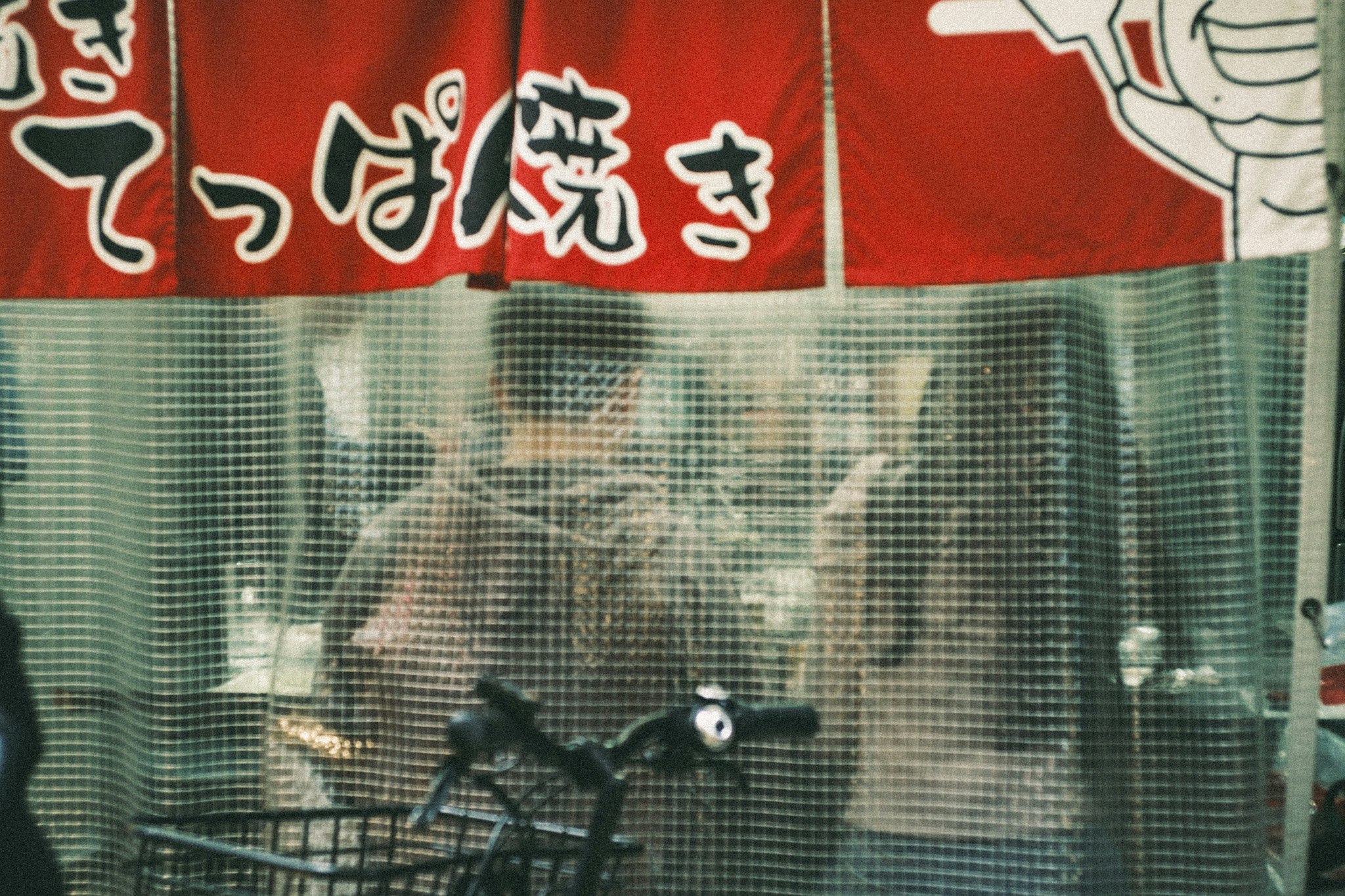 红色横幅与网格墙前展示的自行车