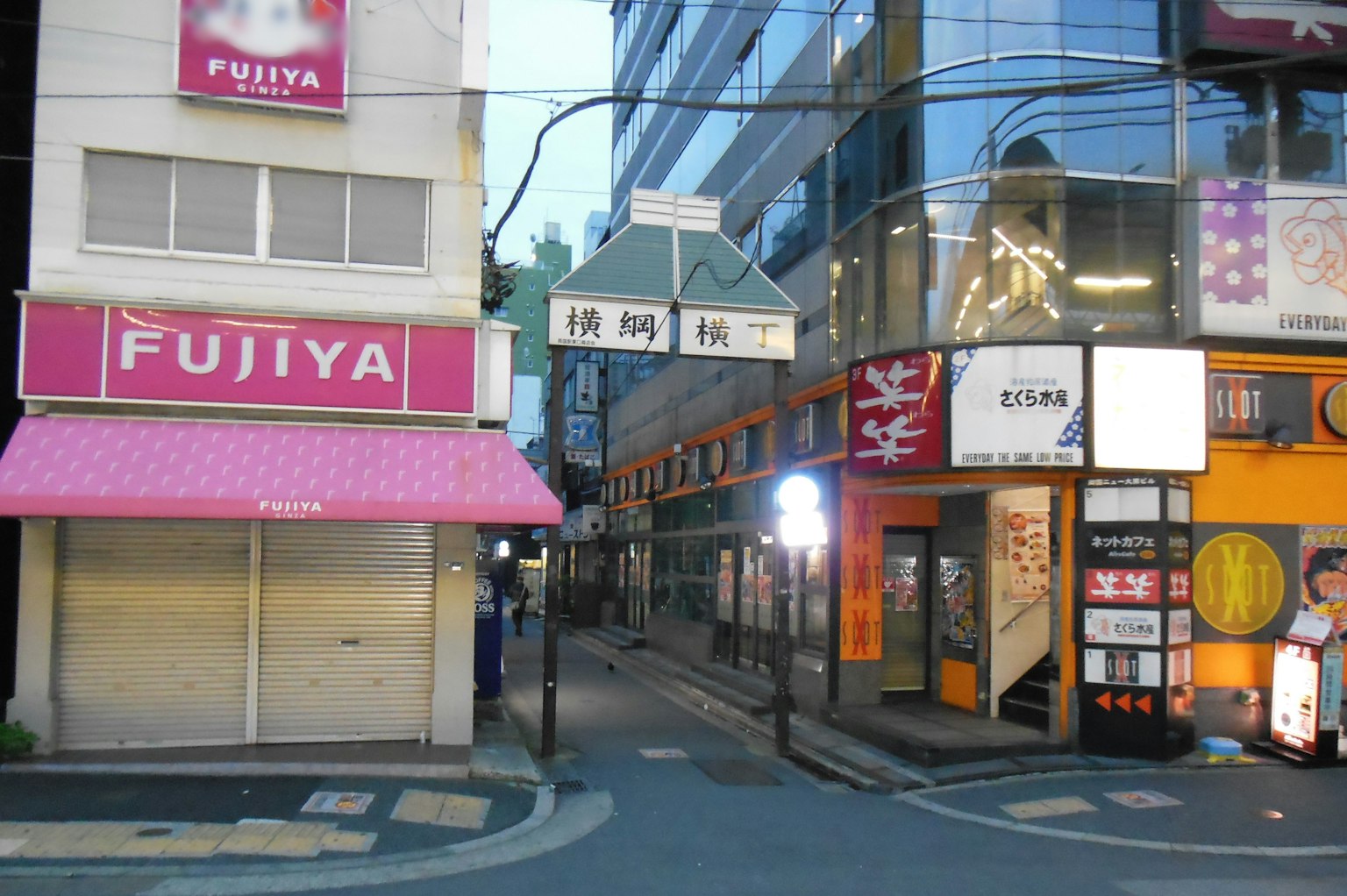 Night scene featuring the Fujiiya sign and commercial buildings