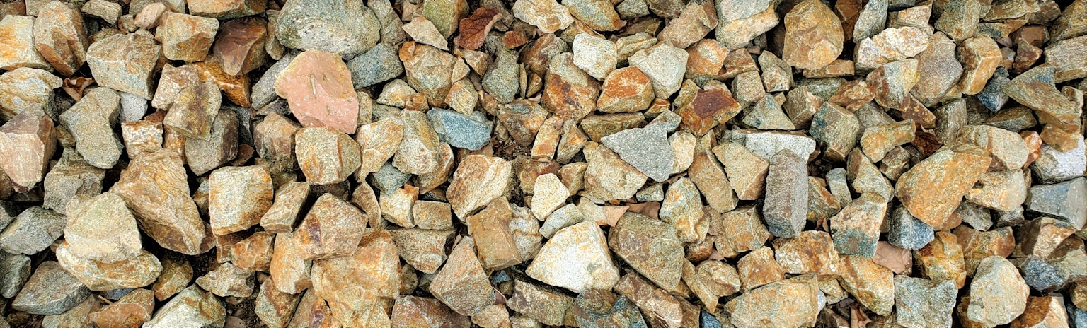 A variety of small stones with different colors scattered on the ground