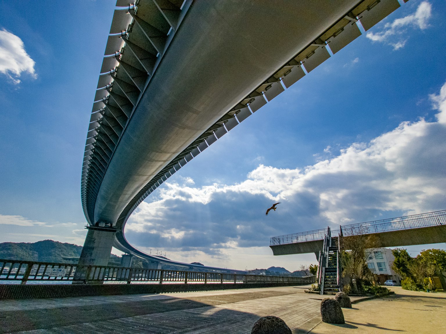 Futuristic designed bridge arches under a blue sky