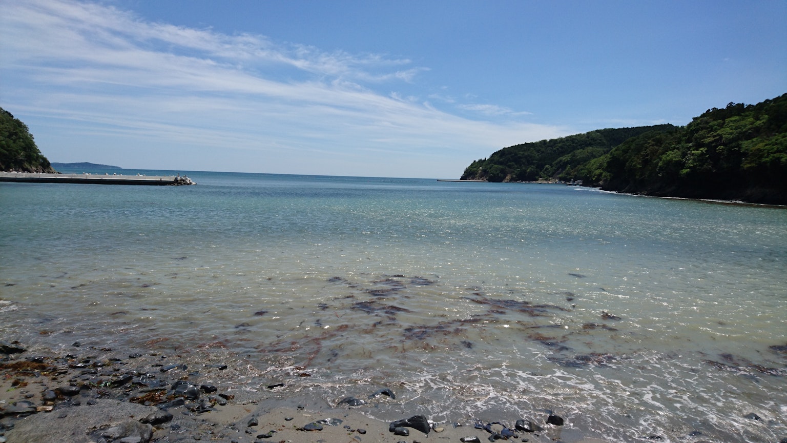 Beautiful landscape with blue sea and sky calm waves lapping at the shore