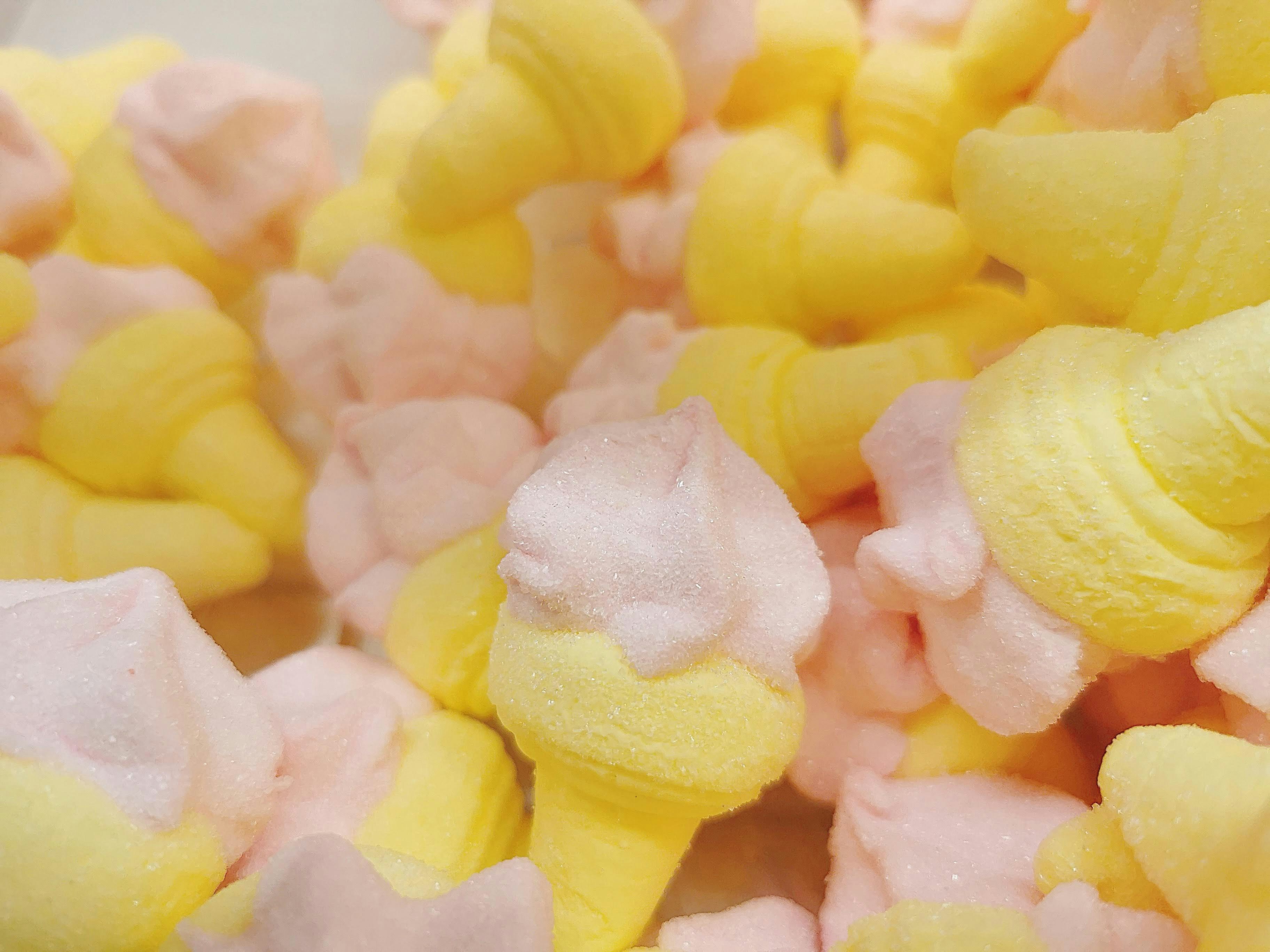 pile of sugar-dusted yellow mango and pink fruit candies