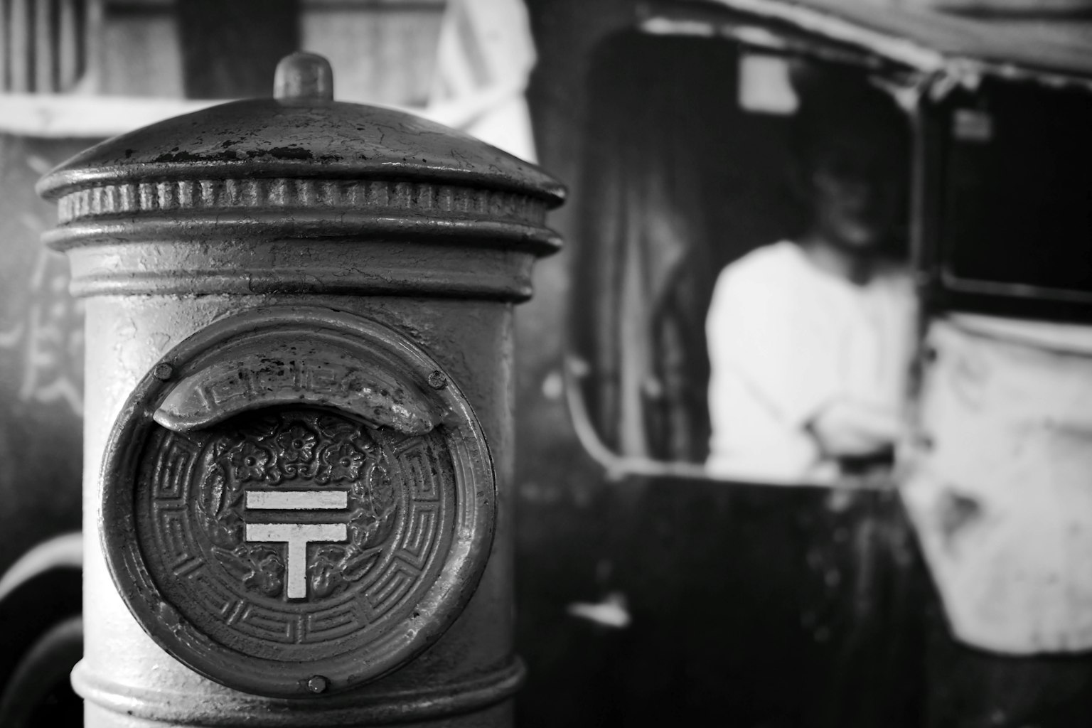 Vintage postal box with a blurred driver in the background
