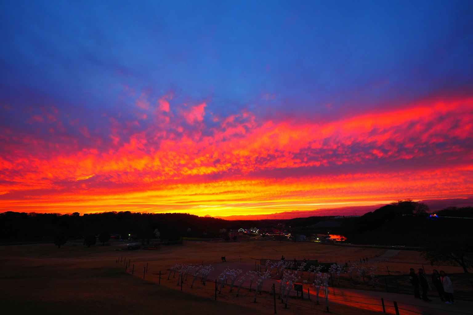 Vibrant sunset sky with orange and pink clouds stretching across the horizon