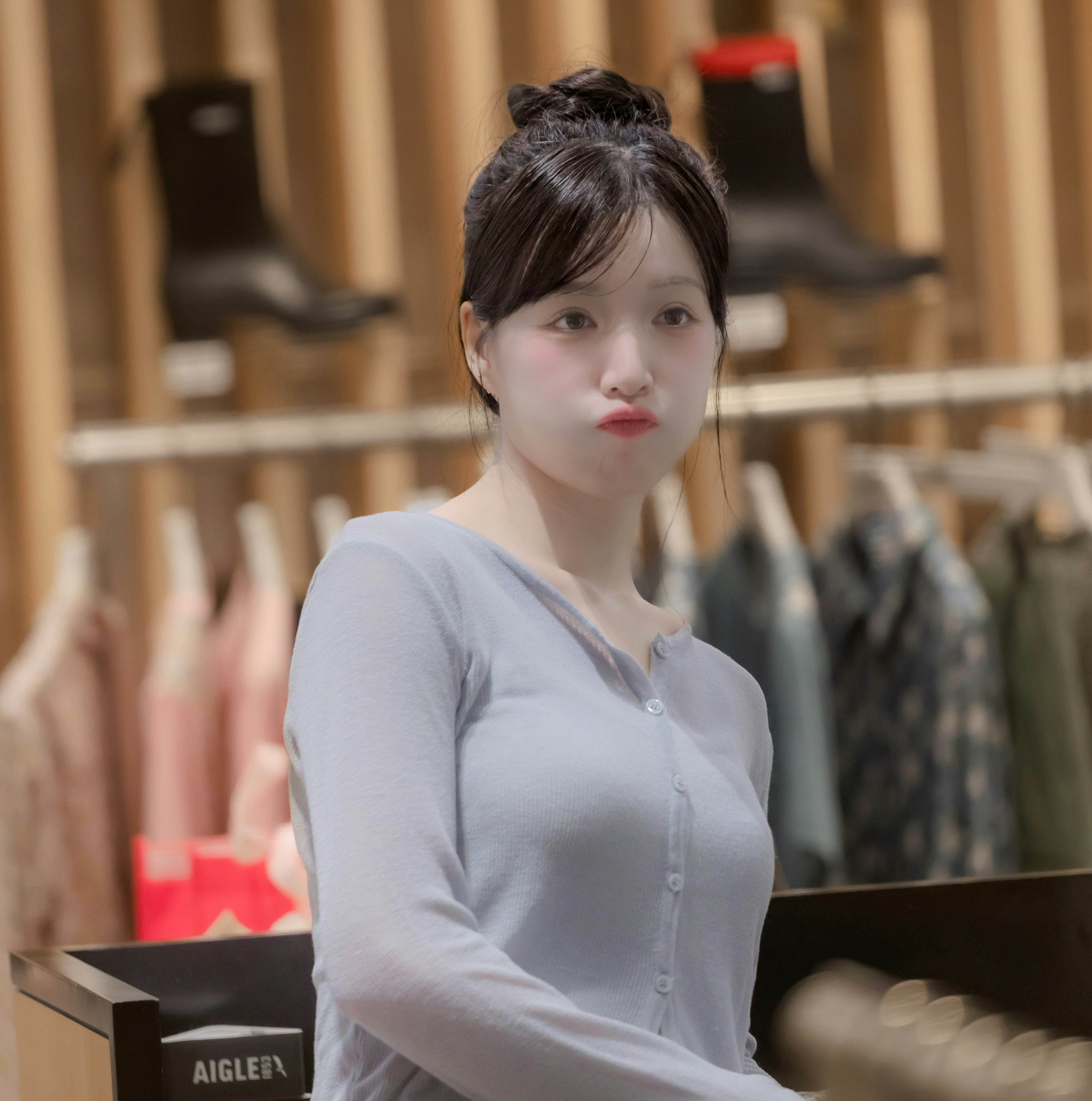 smiling woman in front of a fitting room in a clothing store