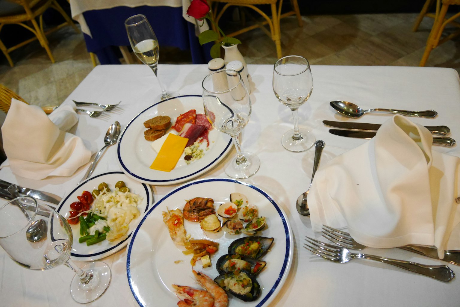 Elegant dining table with seafood dishes and wine glasses