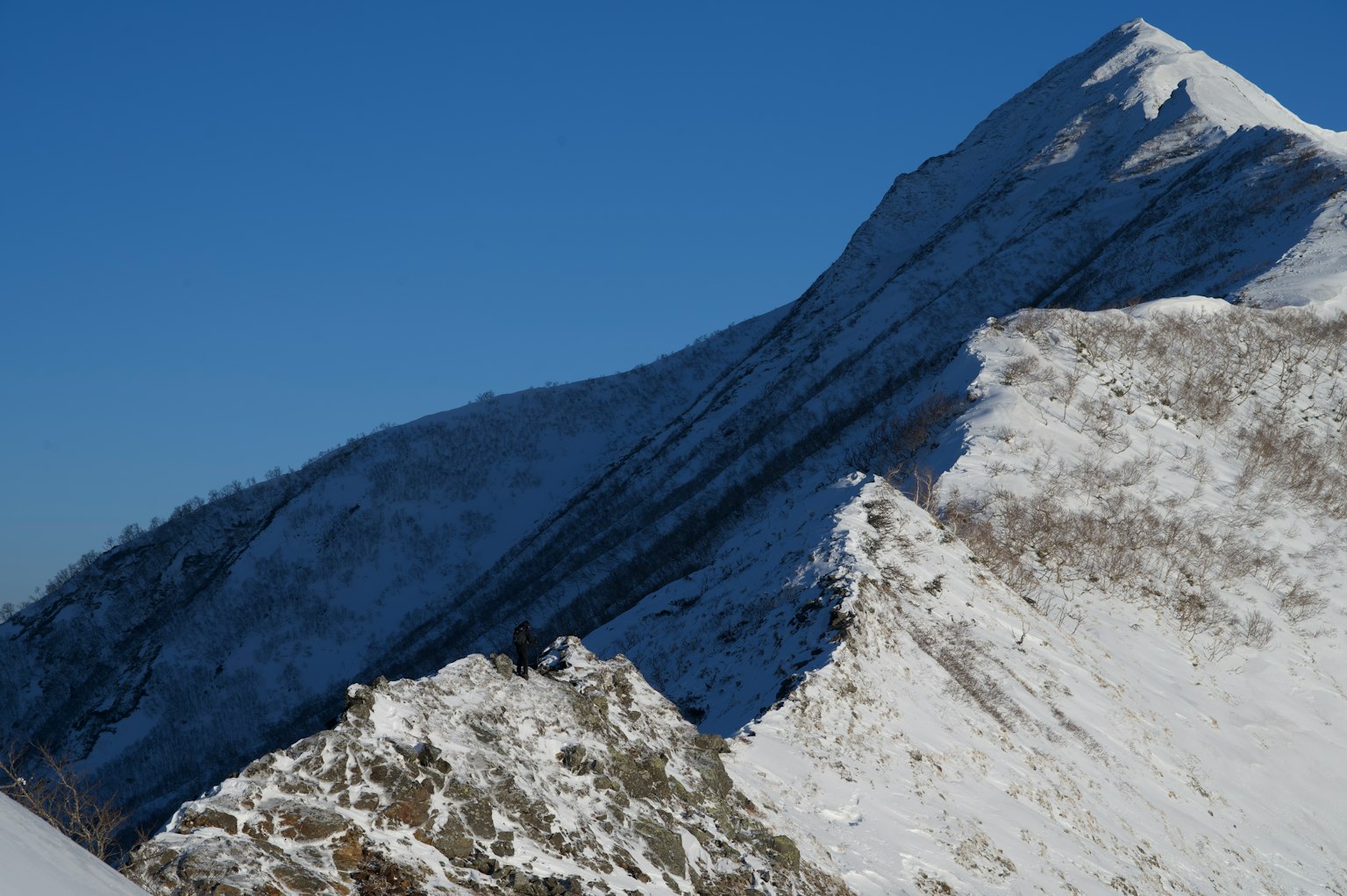 Paesaggio montano innevato con cielo blu chiaro