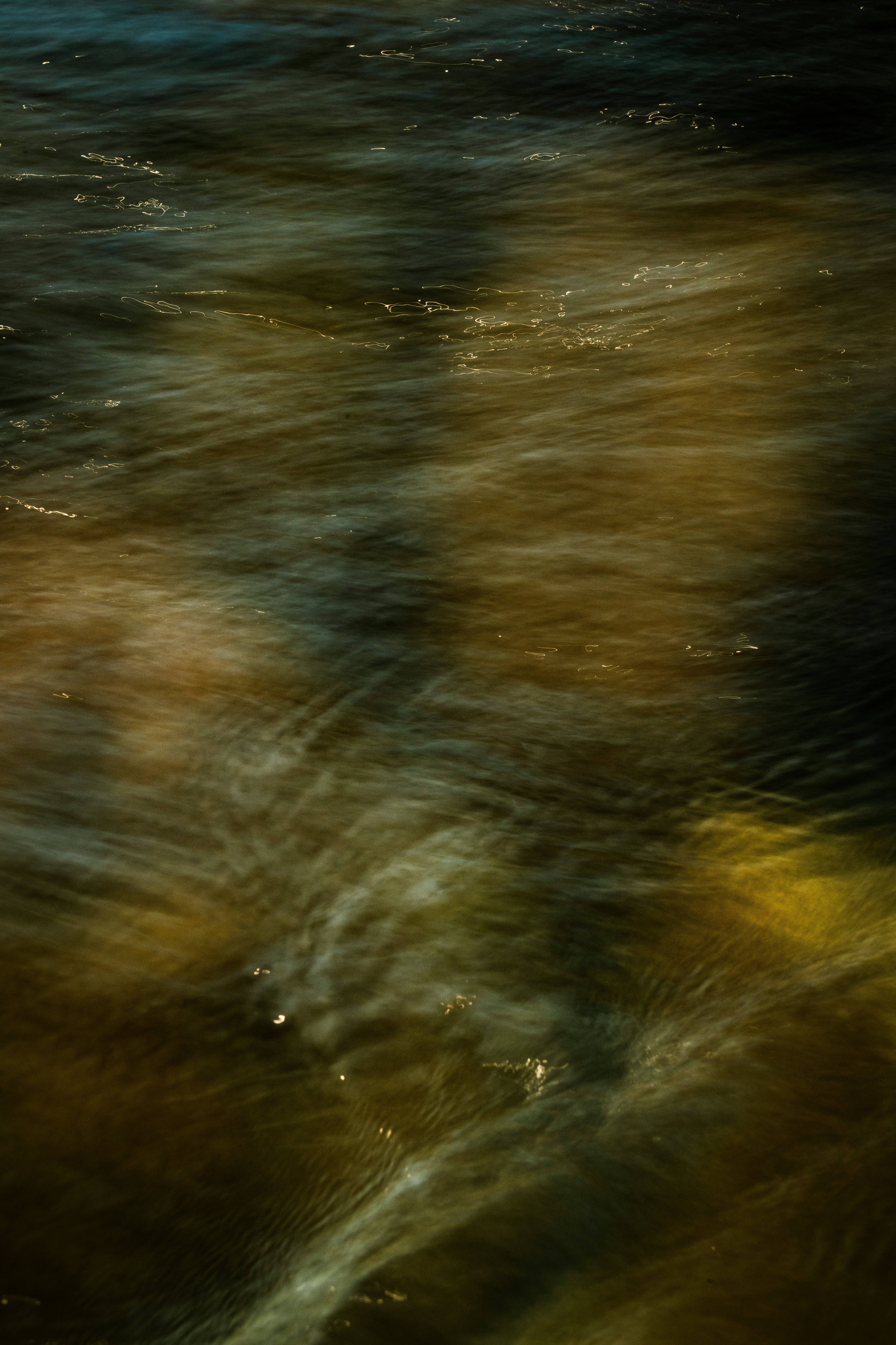 fließendes Flusswasser über der Wasseroberfläche Bild