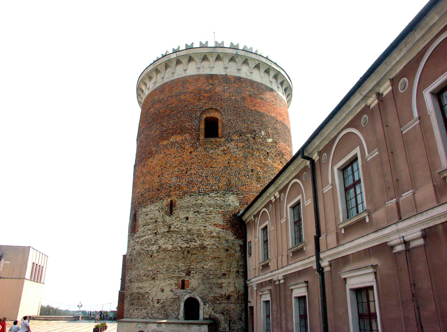 Historical stone tower with surrounding buildings