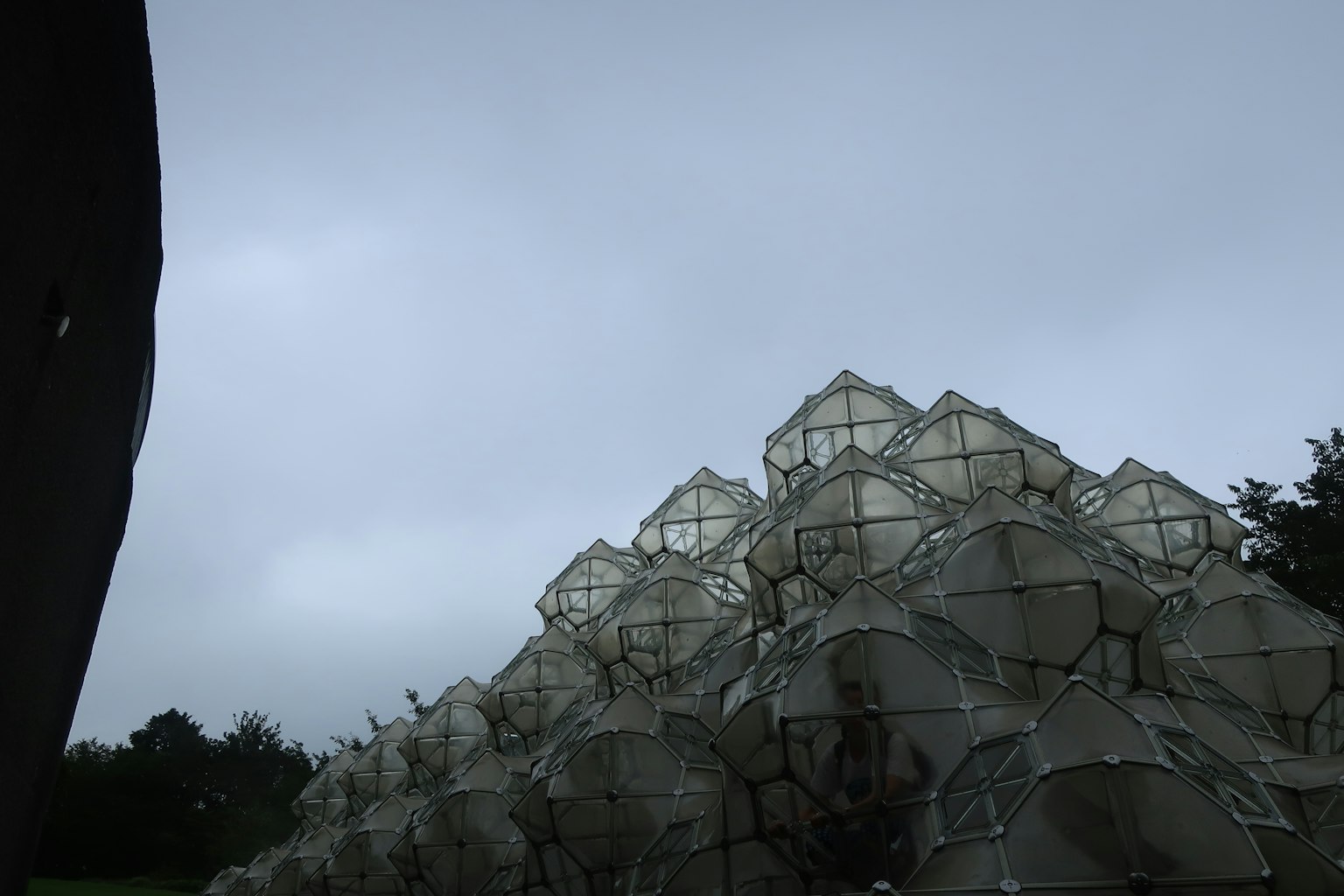 Stack of transparent domes against a cloudy sky