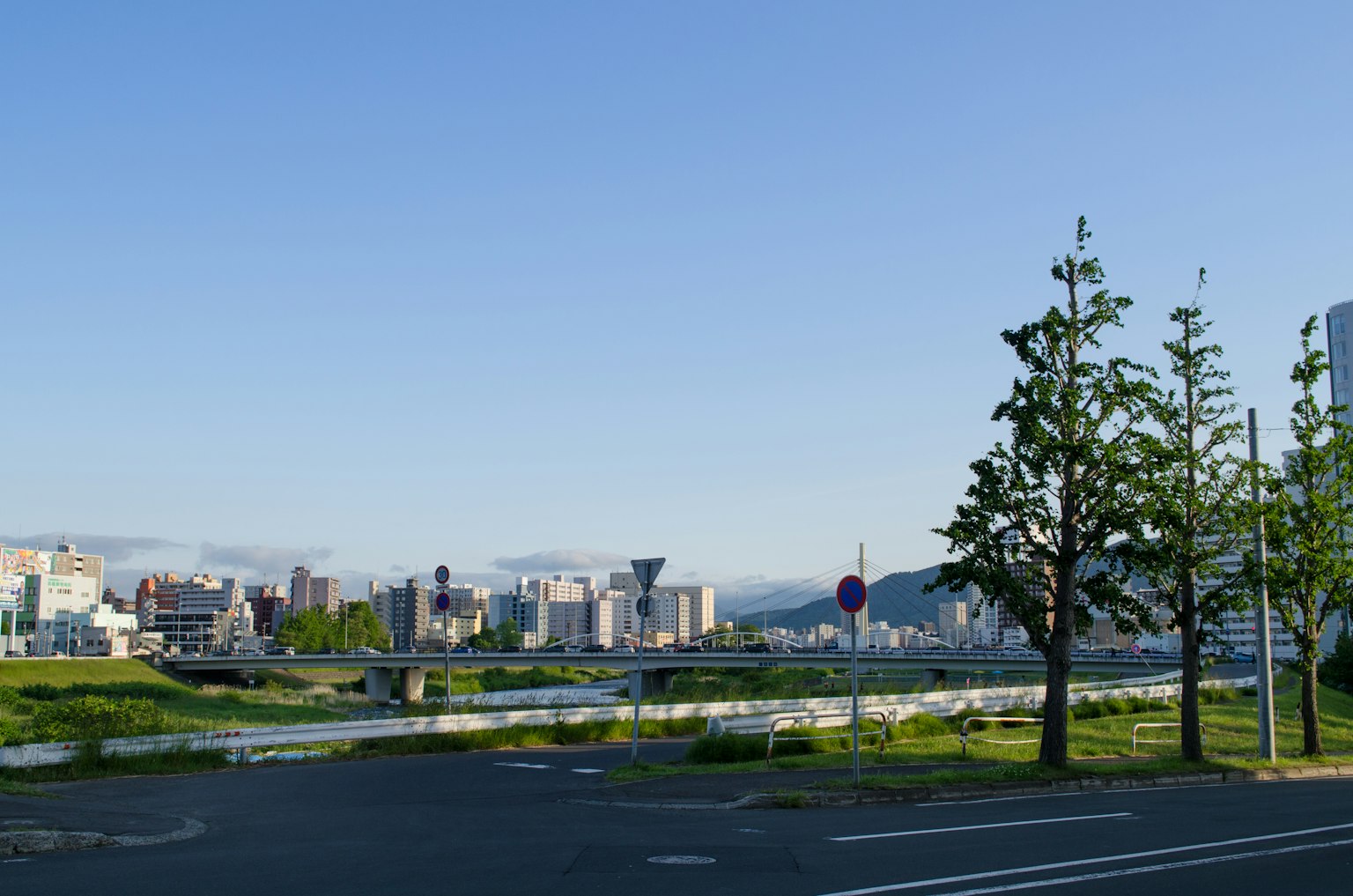 Urban landscape with a river under a clear blue sky