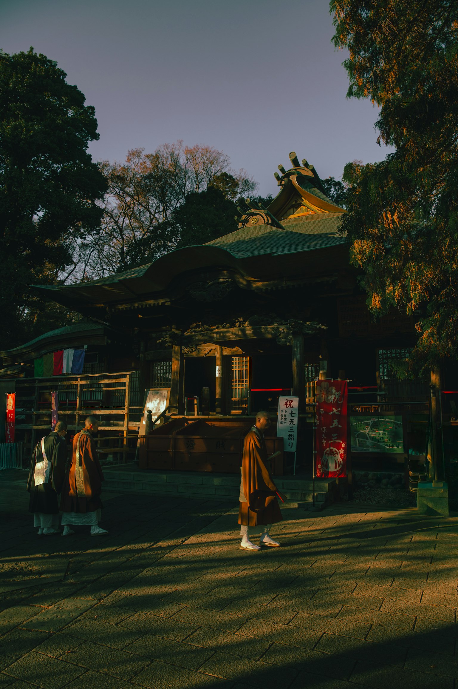 Evening scene of people walking around a quiet temple