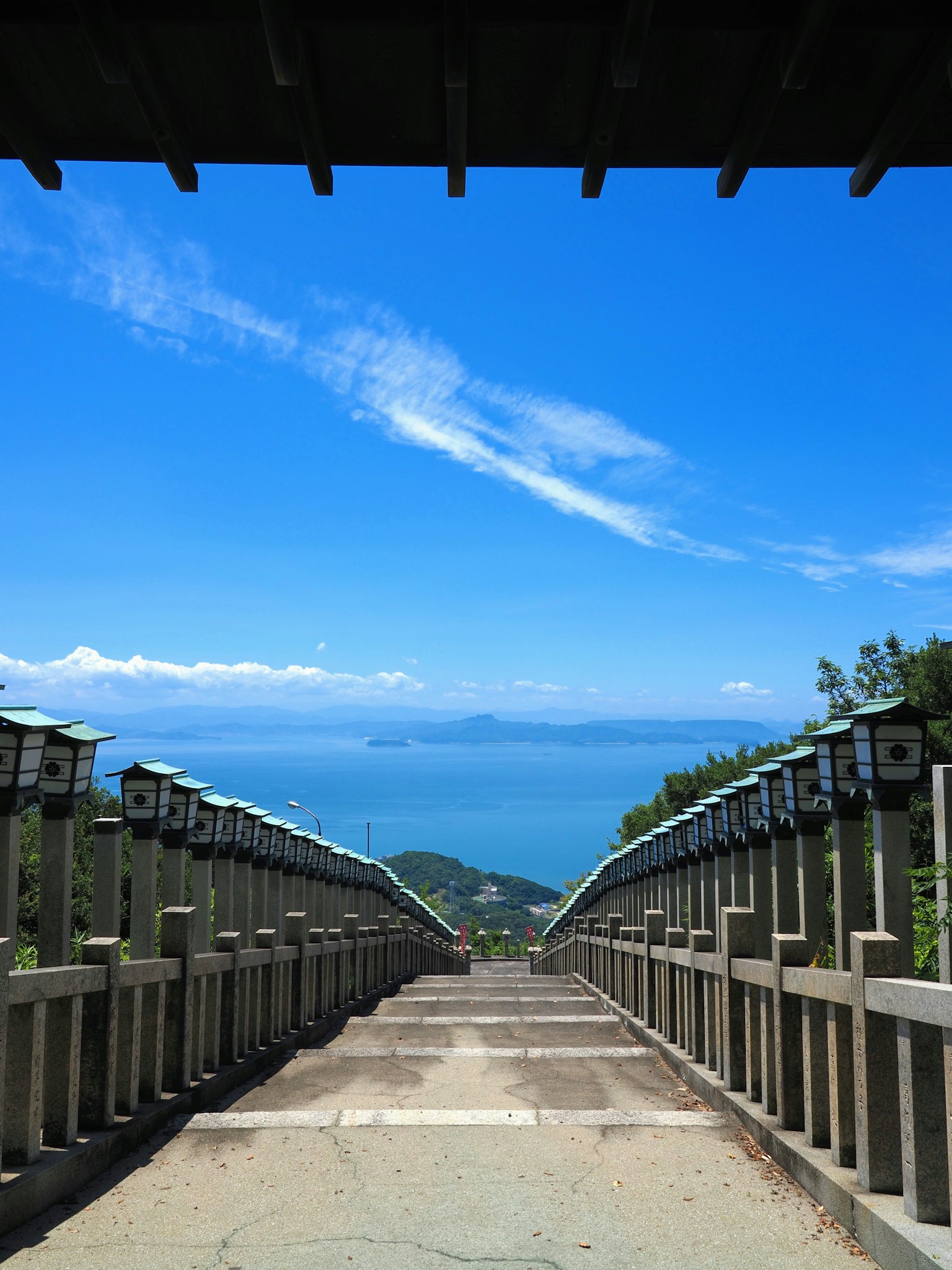 Lunga scalinata con vista sul cielo blu e sul mare