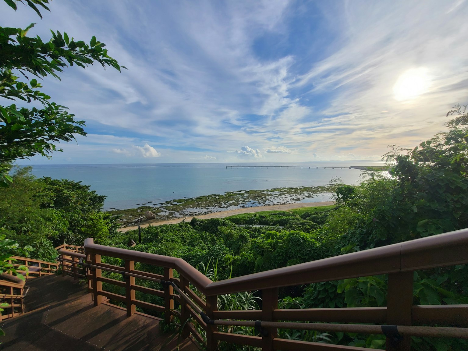 Vue panoramique sur l'océan avec ciel bleu et terrasse en bois