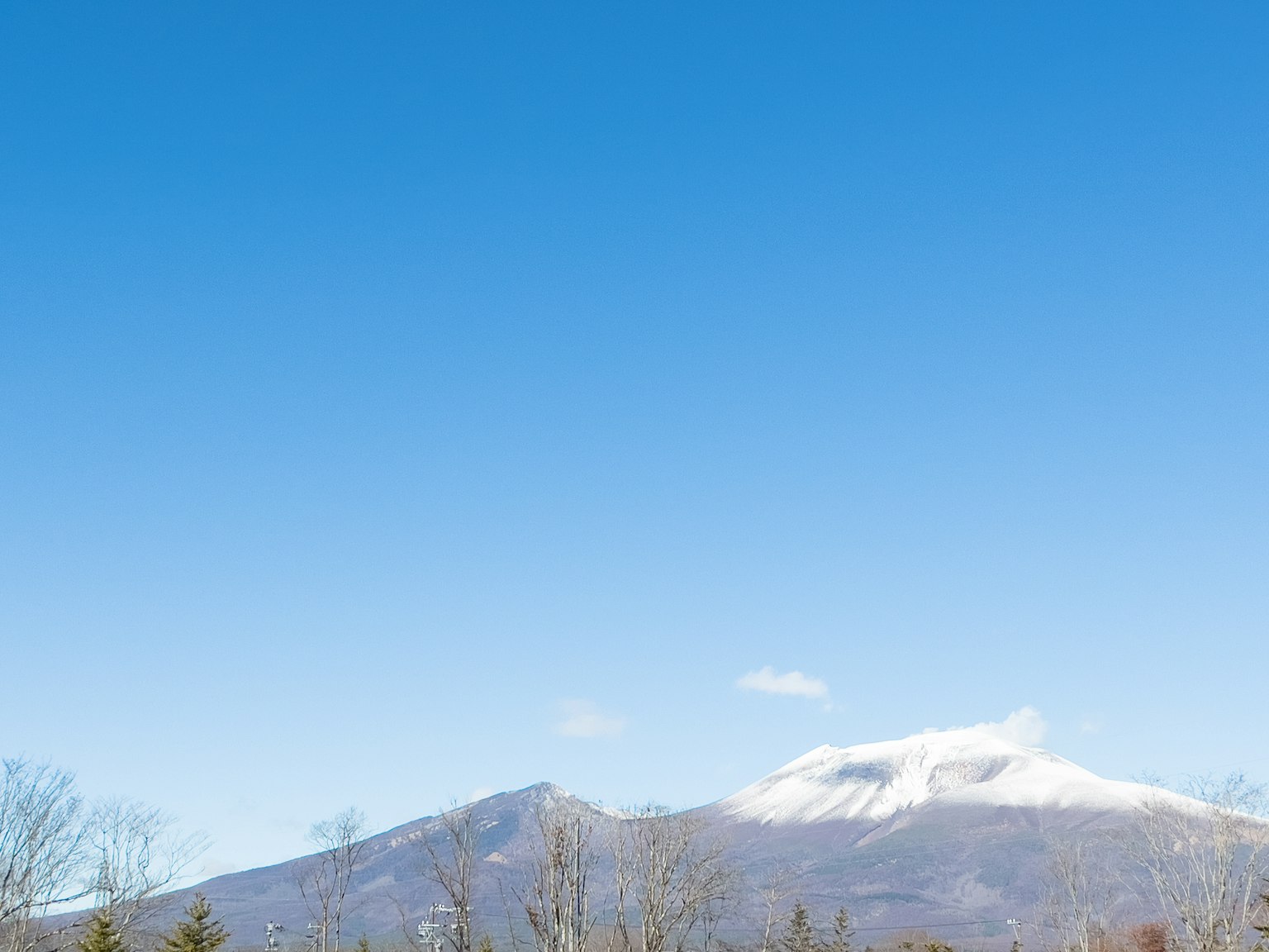 Scenic view of snow-capped mountains under a clear blue sky