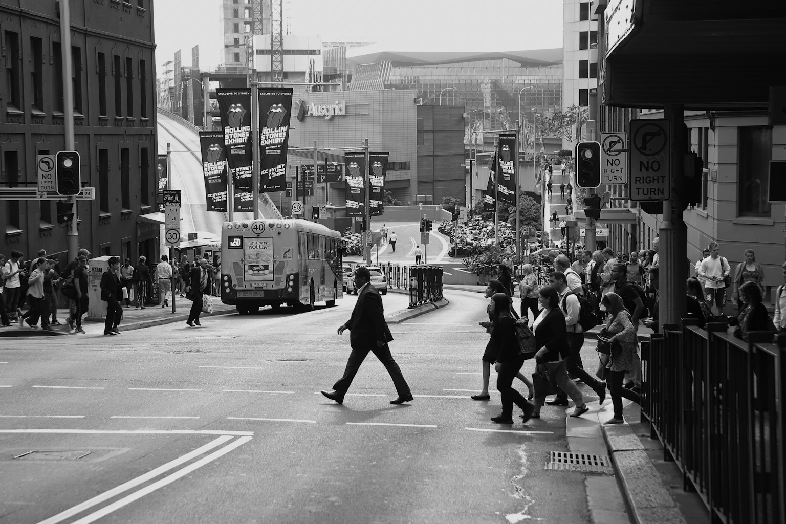 People crossing the street in a monochrome cityscape