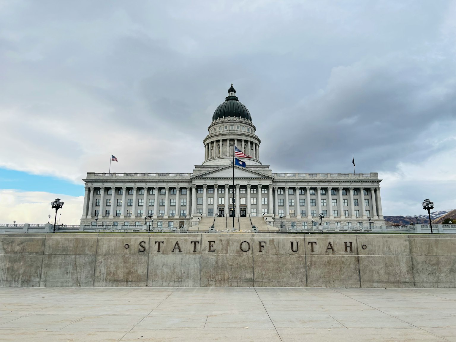 Front view of the Utah State Capitol building under gray clouds