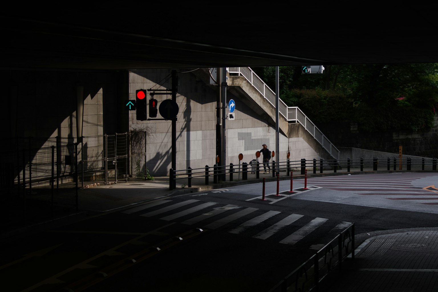 A scene featuring stairs and a traffic light in a dark street