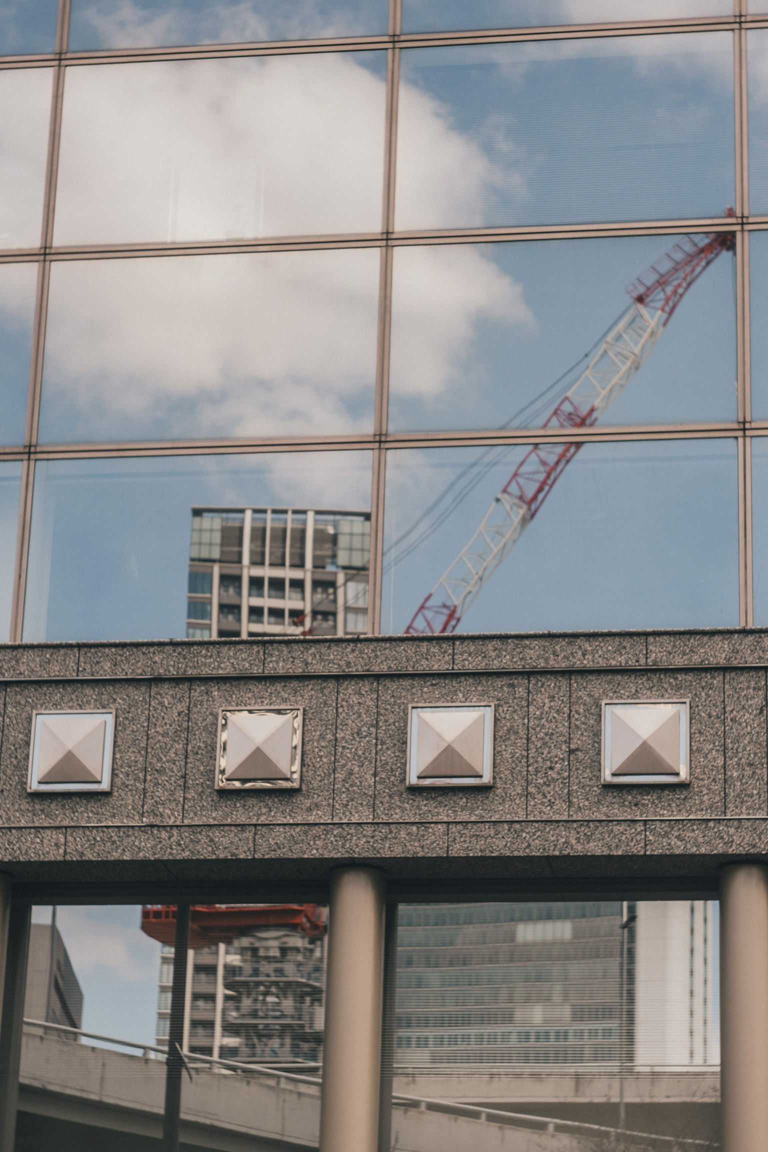 Reflection of a crane and building in glass windows