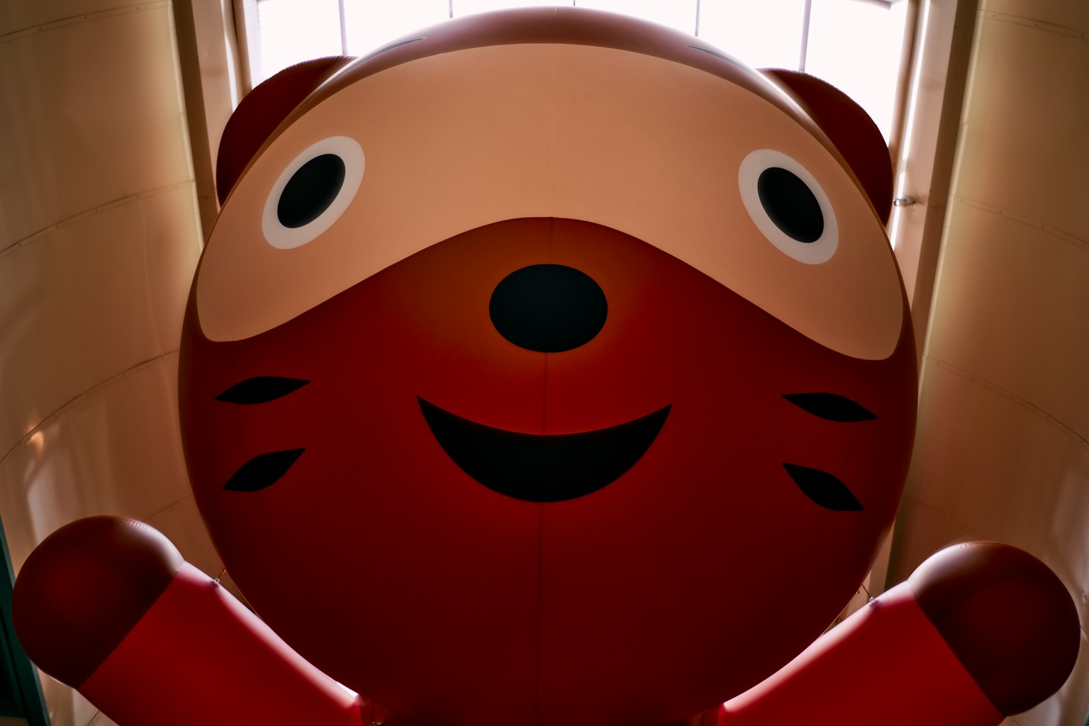 Large red ninja character figure smiling and looking at the camera