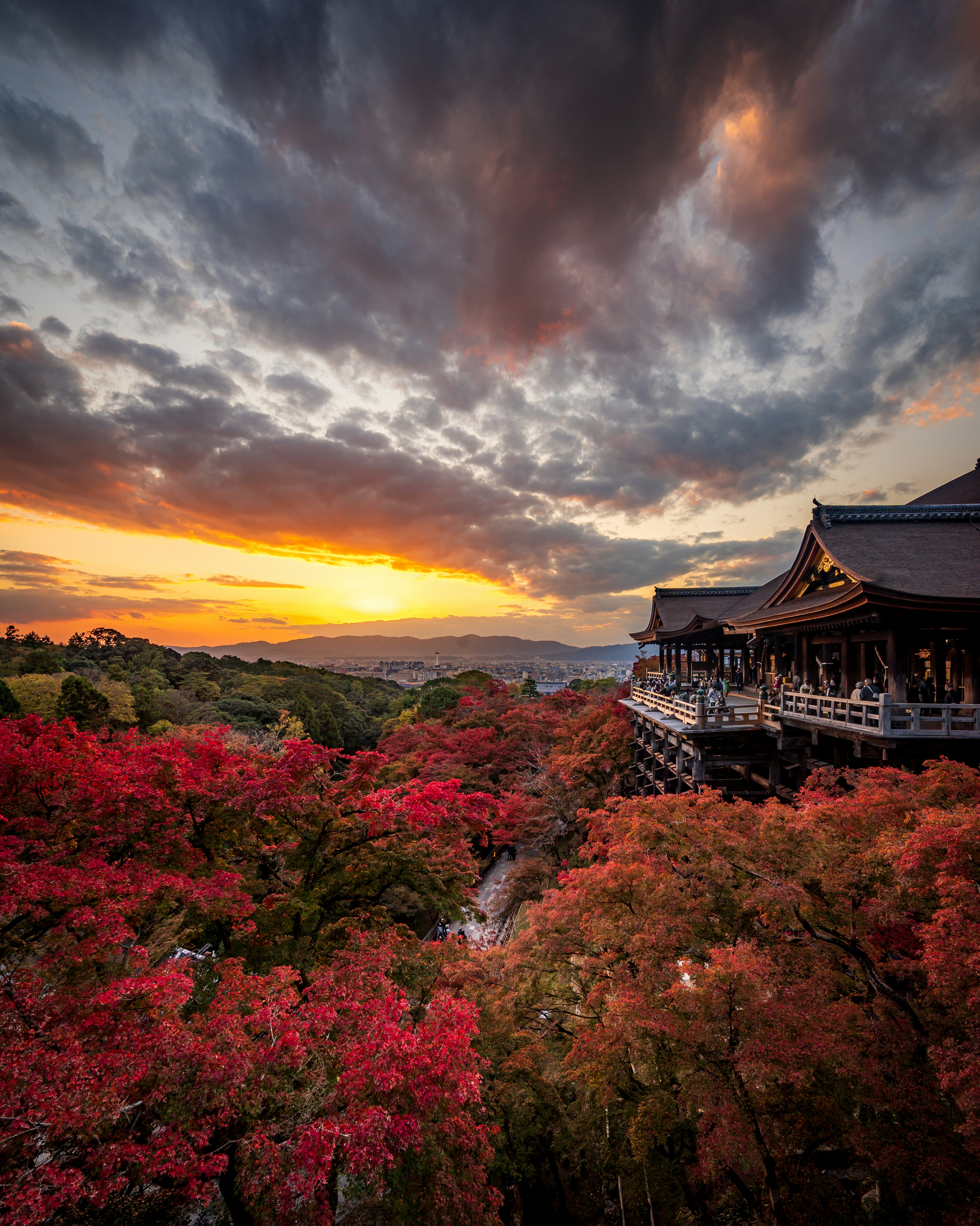 temple veranda surrounded by vivid autumn foliage under a sunset sky