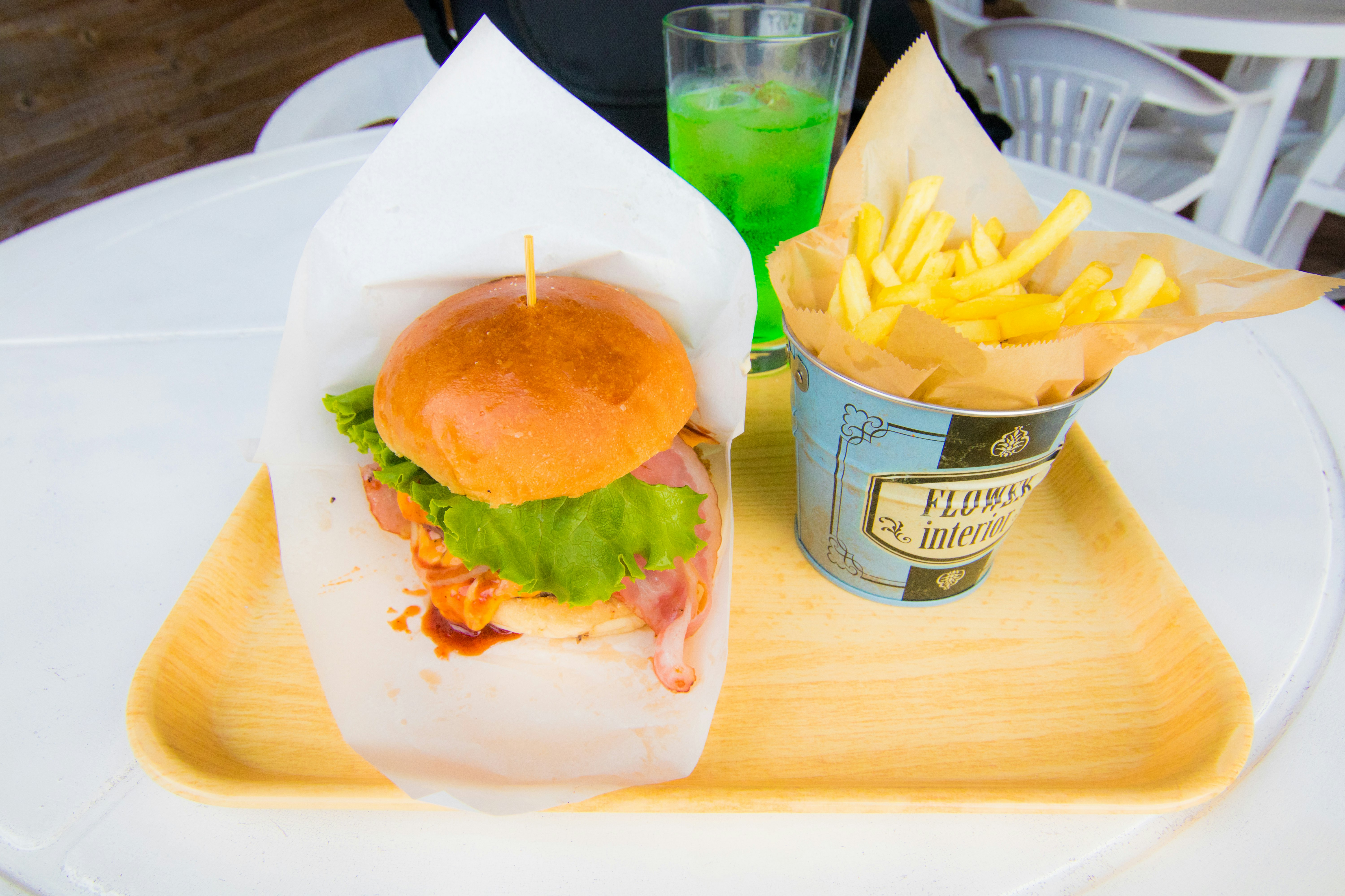 Fast-food set with a burger, fries, and melon soda