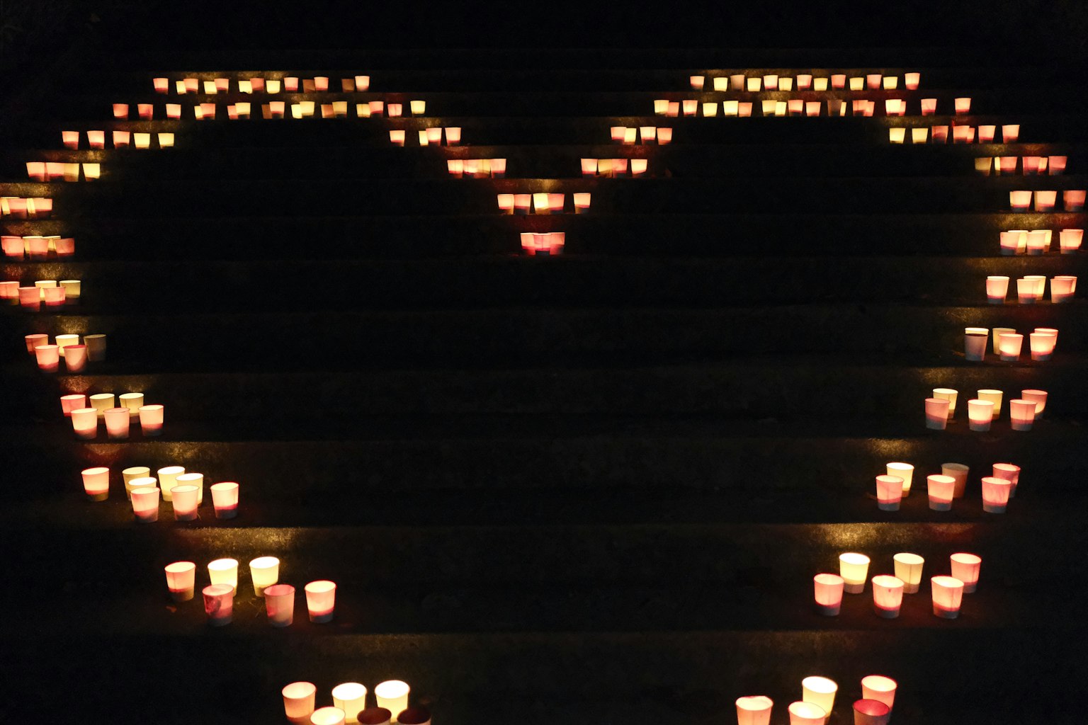 Heart shape made of candles arranged on stairs