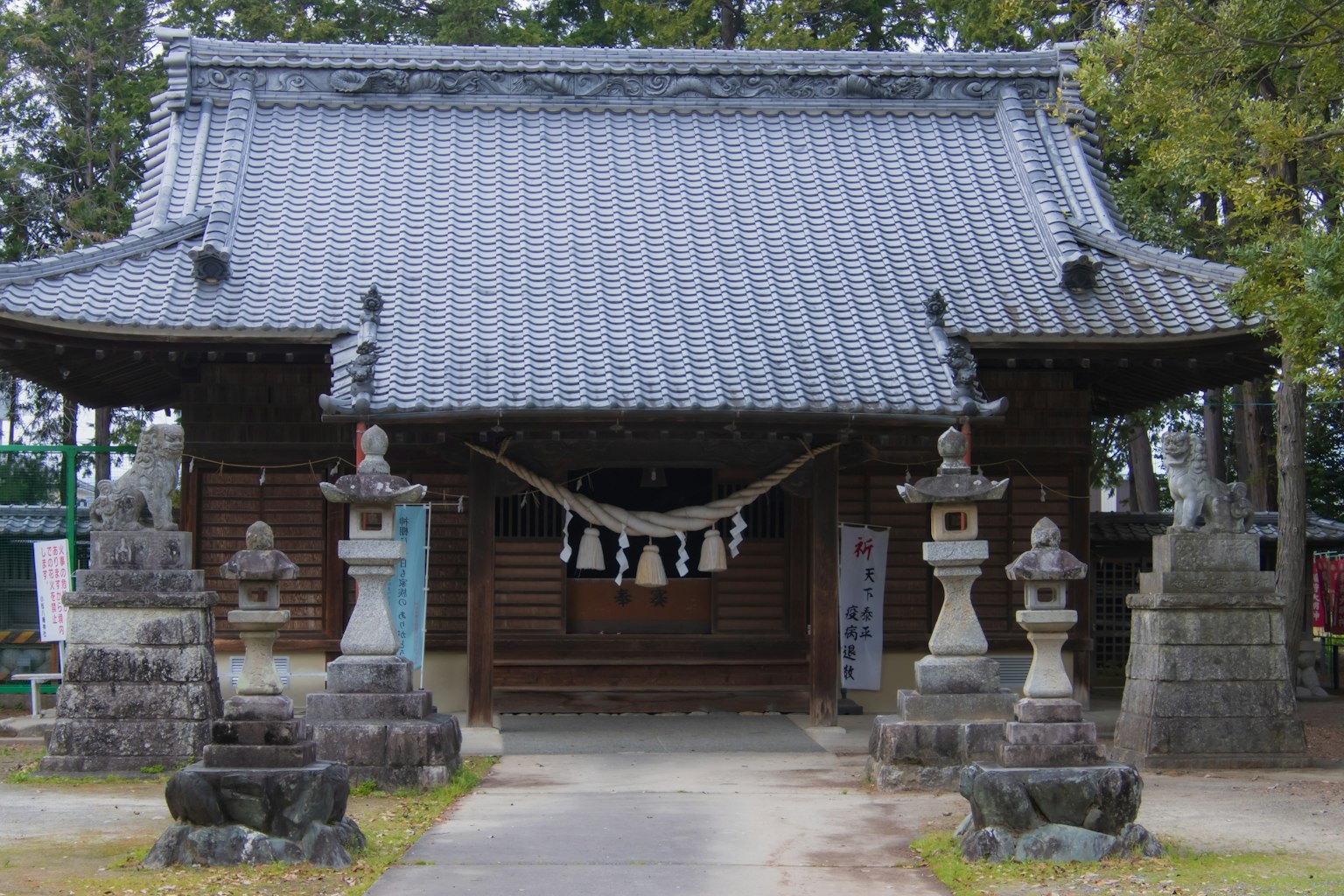 Traditional Japanese shrine building with stone lanterns
