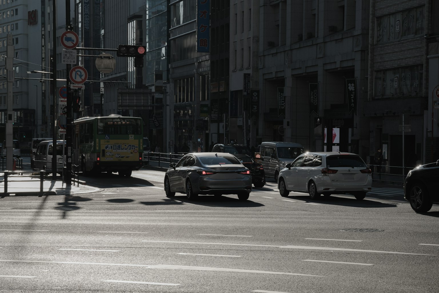 Street scene showing traffic with vehicles and buildings