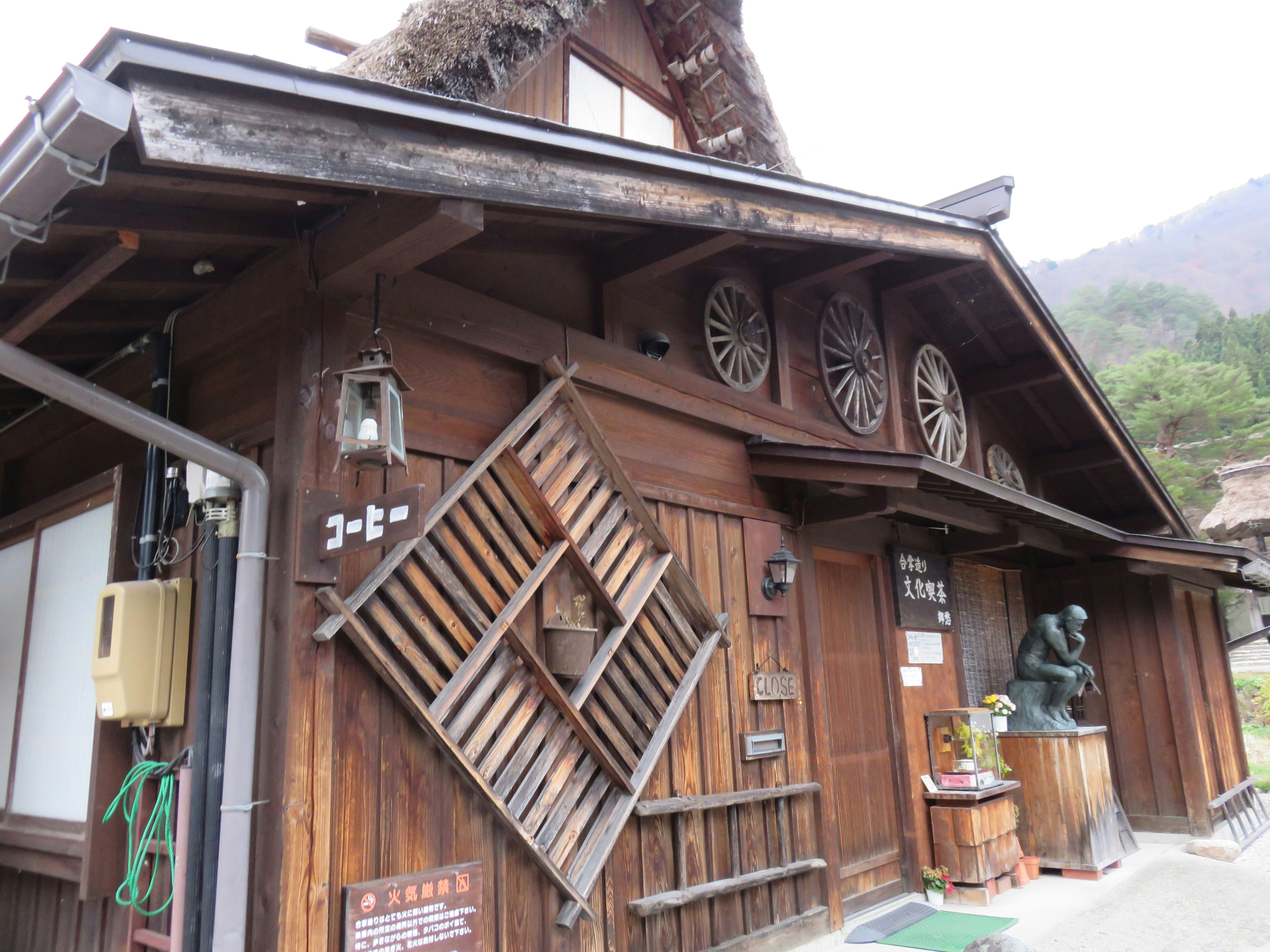 wooden cafe storefront with signage in a mountain valley