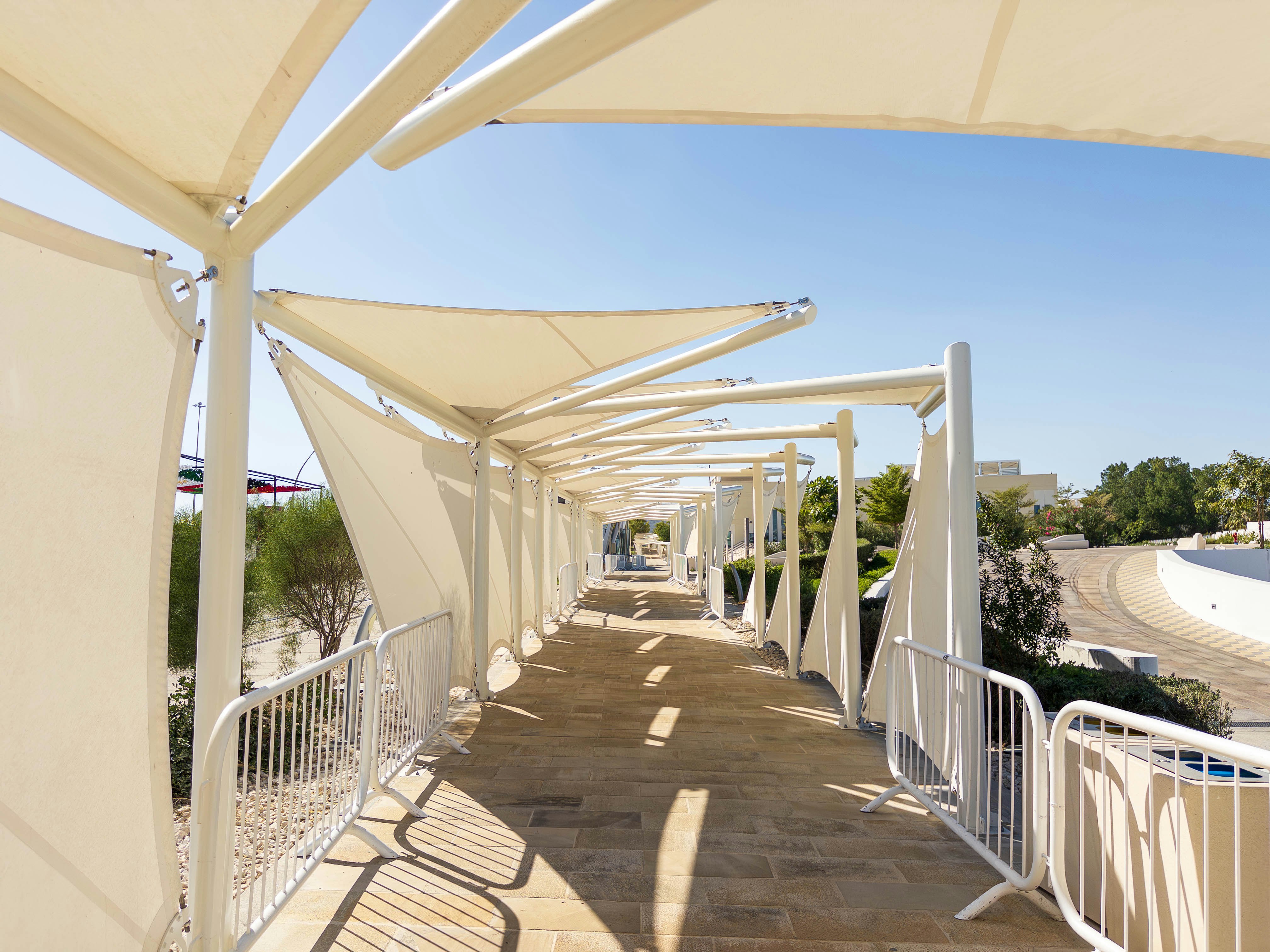 long covered walkway with white canopy