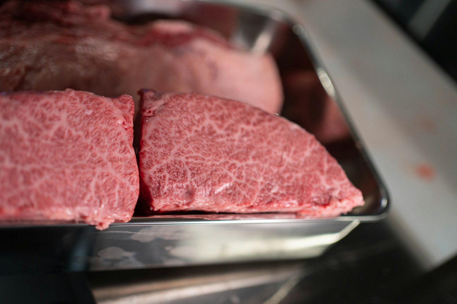 Premium wagyu beef slices arranged on a tray
